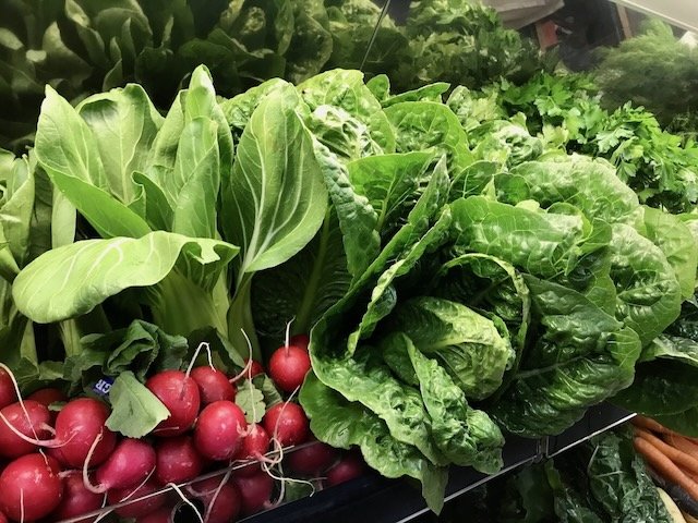 Fresh vegetables display featuring radishes and leafy greens