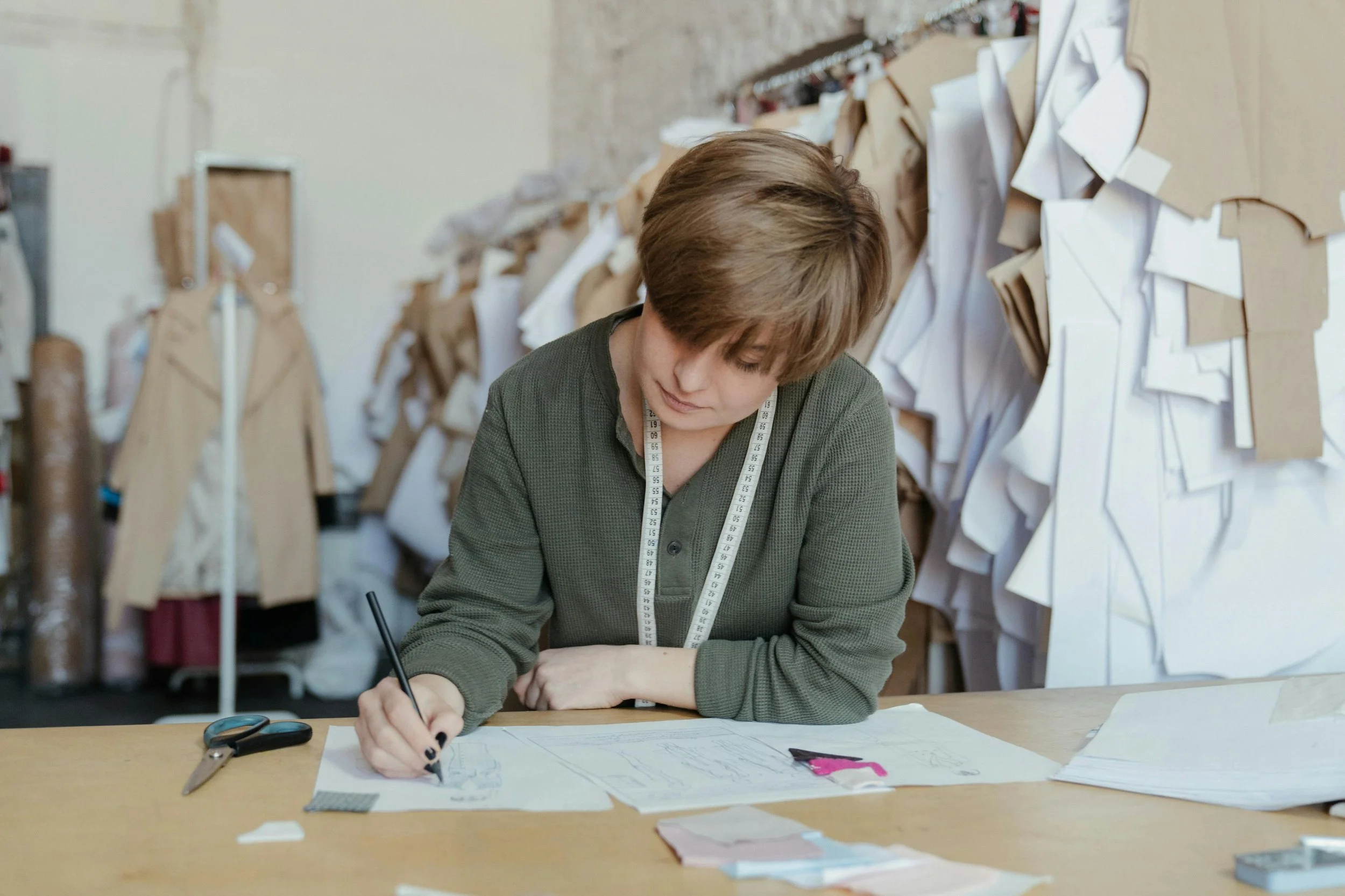Fashion designer sketching new garment ideas at Perfection Clothing Ltd, creators of the PINNS trousers lines