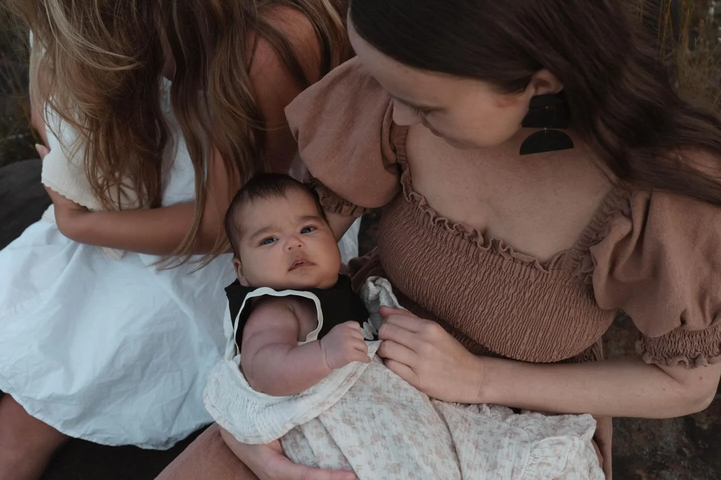 They grow so fast, and every little stage is beautiful.
Newborns bring that quiet, tiny magic, the soft sighs, curled up fingers, and sleepy cuddles that feel like they could disappear in a blink.
Older babies bring their own kind of wonder, bright e