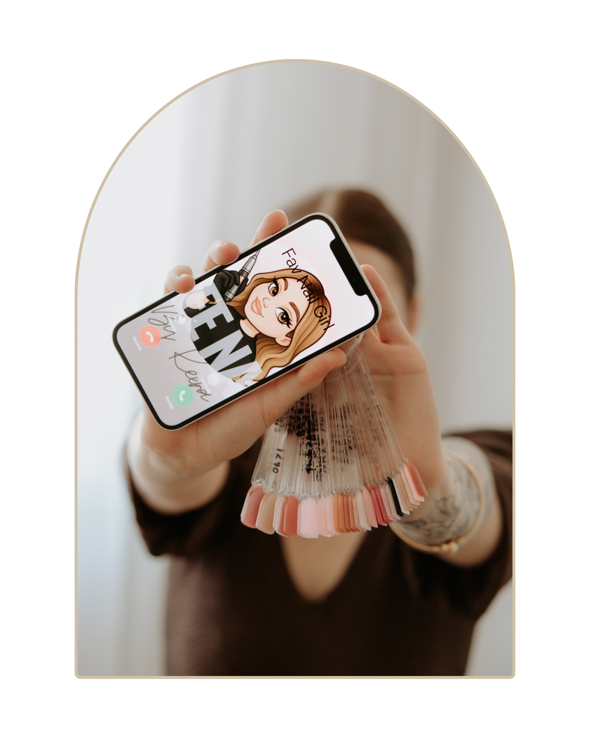 Person holding a phone showing a cartoon avatar of a woman with styled hair, with a fan of nail color swatches in the foreground.