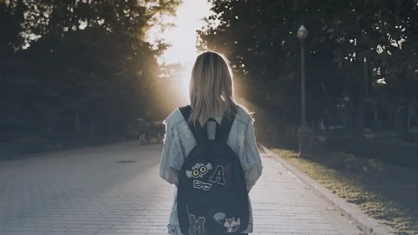 woman facing a path ahead