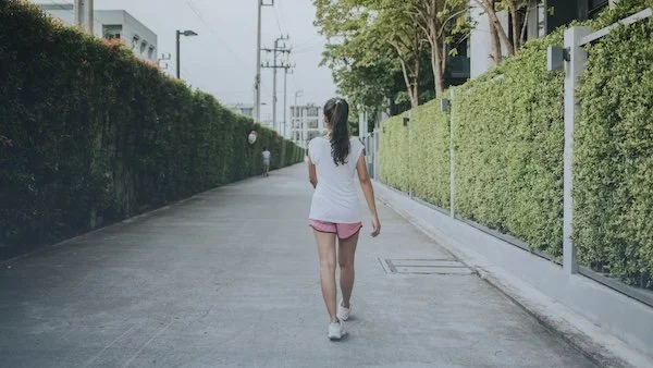 woman taking a walk around the neighborhood