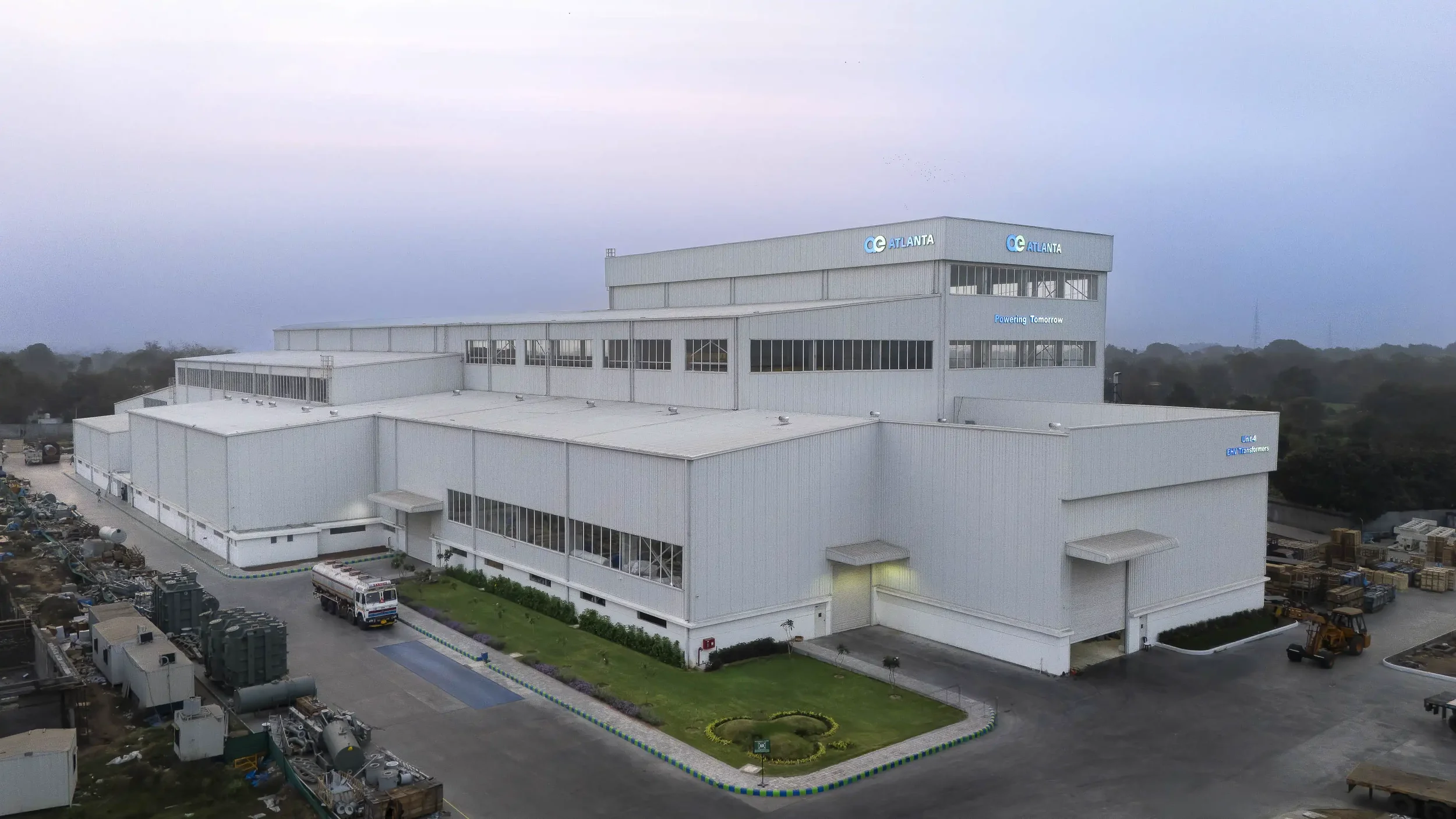 An aerial exterior shot of the Atlanta Transformers factory building at dusk
