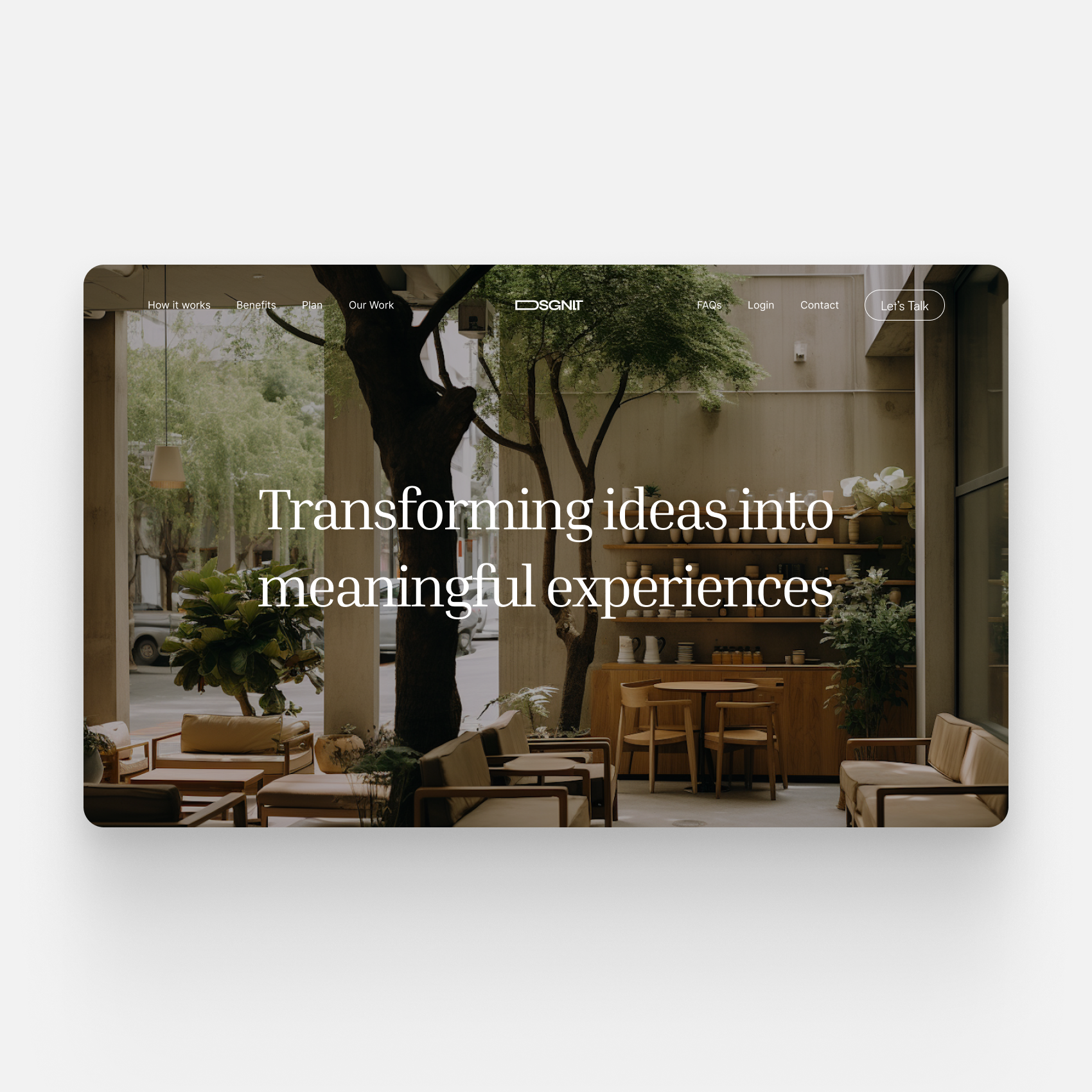 Website homepage with a natural indoor setting, wooden furniture, a large tree, and a message 'Transforming ideas into meaningful experiences'