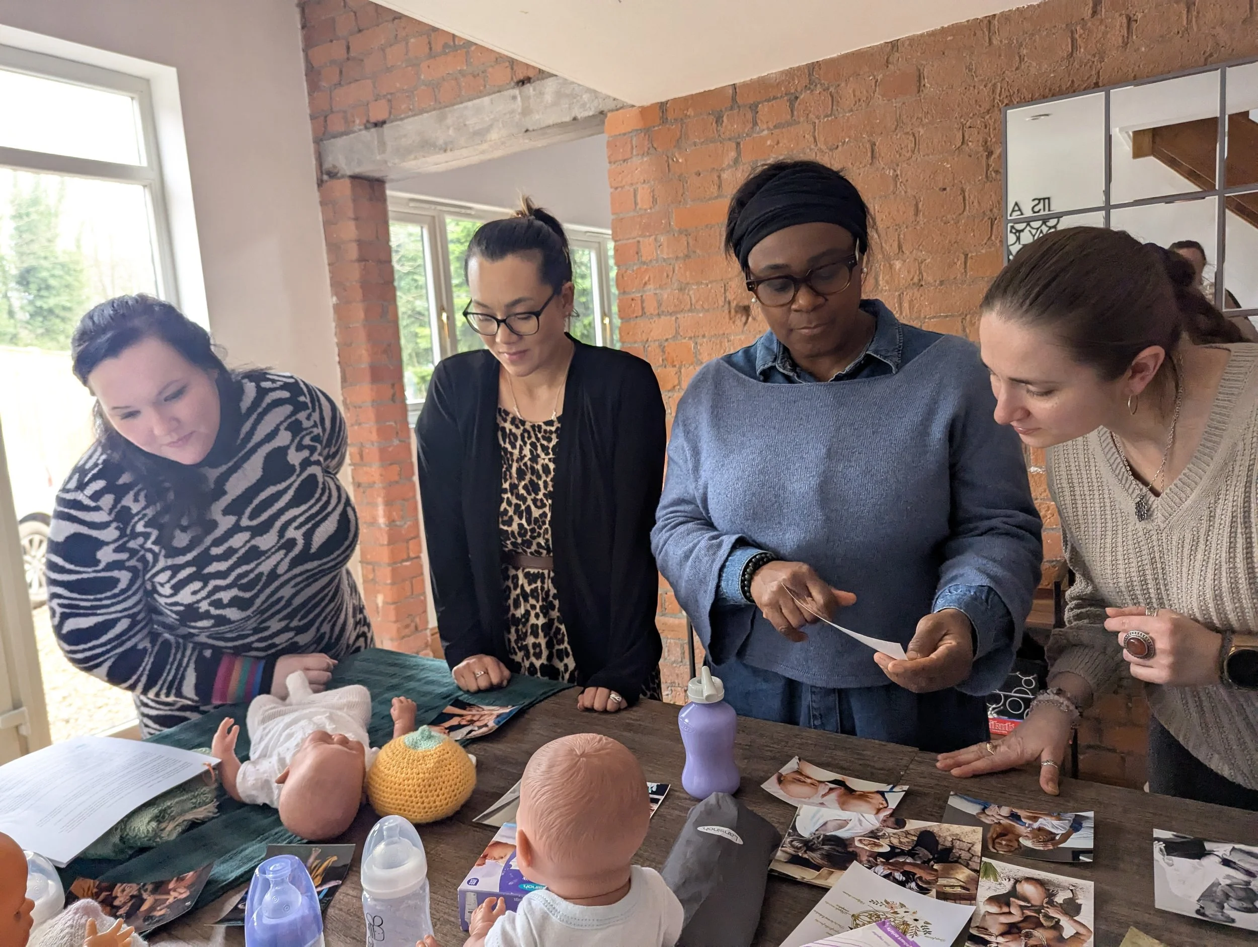 Our doulas learning about infant feeding, breast feeding and formula feeding