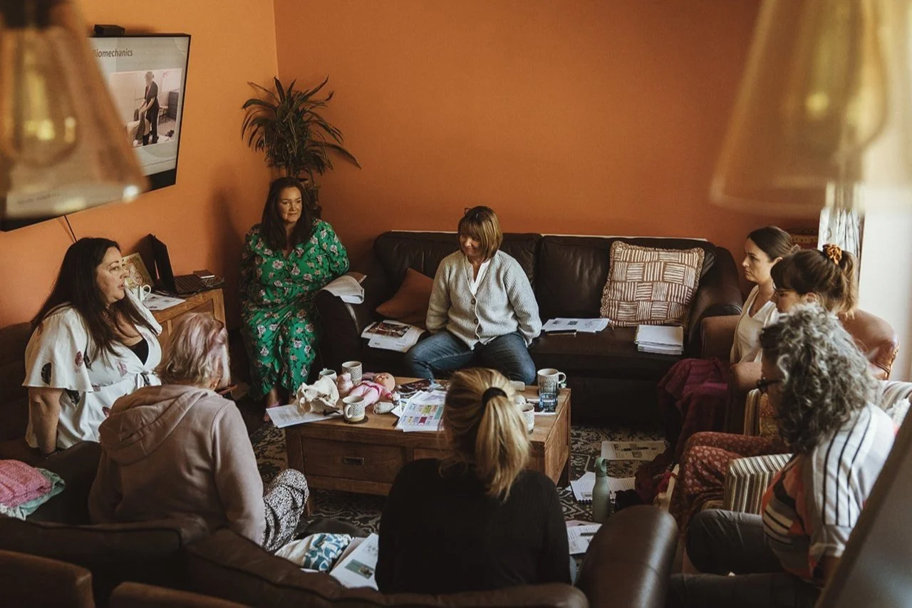 Doula training course in session, a small group of students seated in a circle with course materials, led by Jemma at The Doula Training Foundation