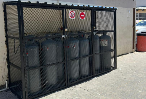A fenced enclosure with multiple LP Gas tanks stored inside.