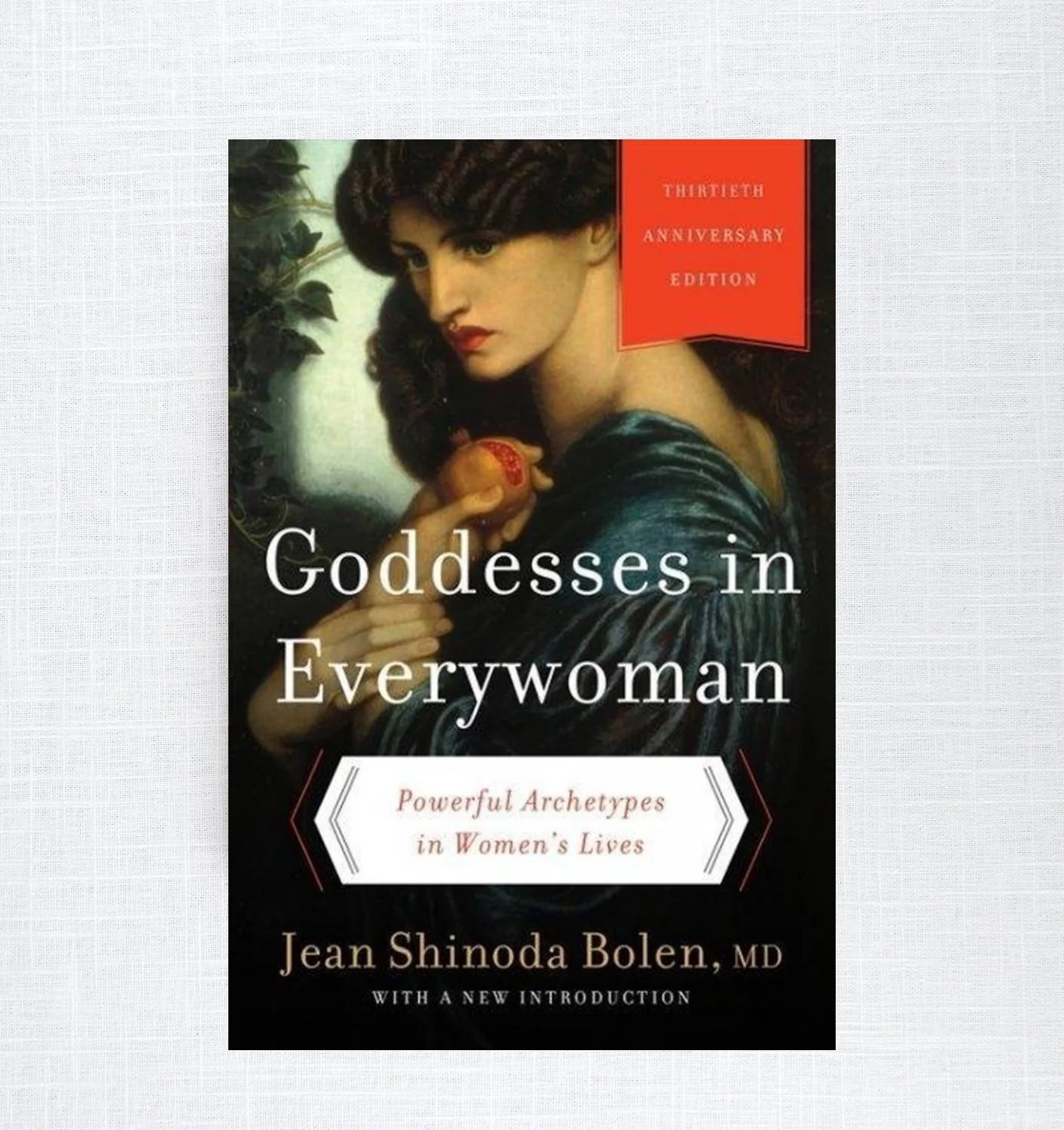 Book cover titled "Goddesses in Everywoman" by Jean Shinoda Bolen, MD, celebrating its 30th anniversary edition. Features an illustration resembling a classical painting of a woman with dark hair, holding a fruit, and surrounded by greenery.