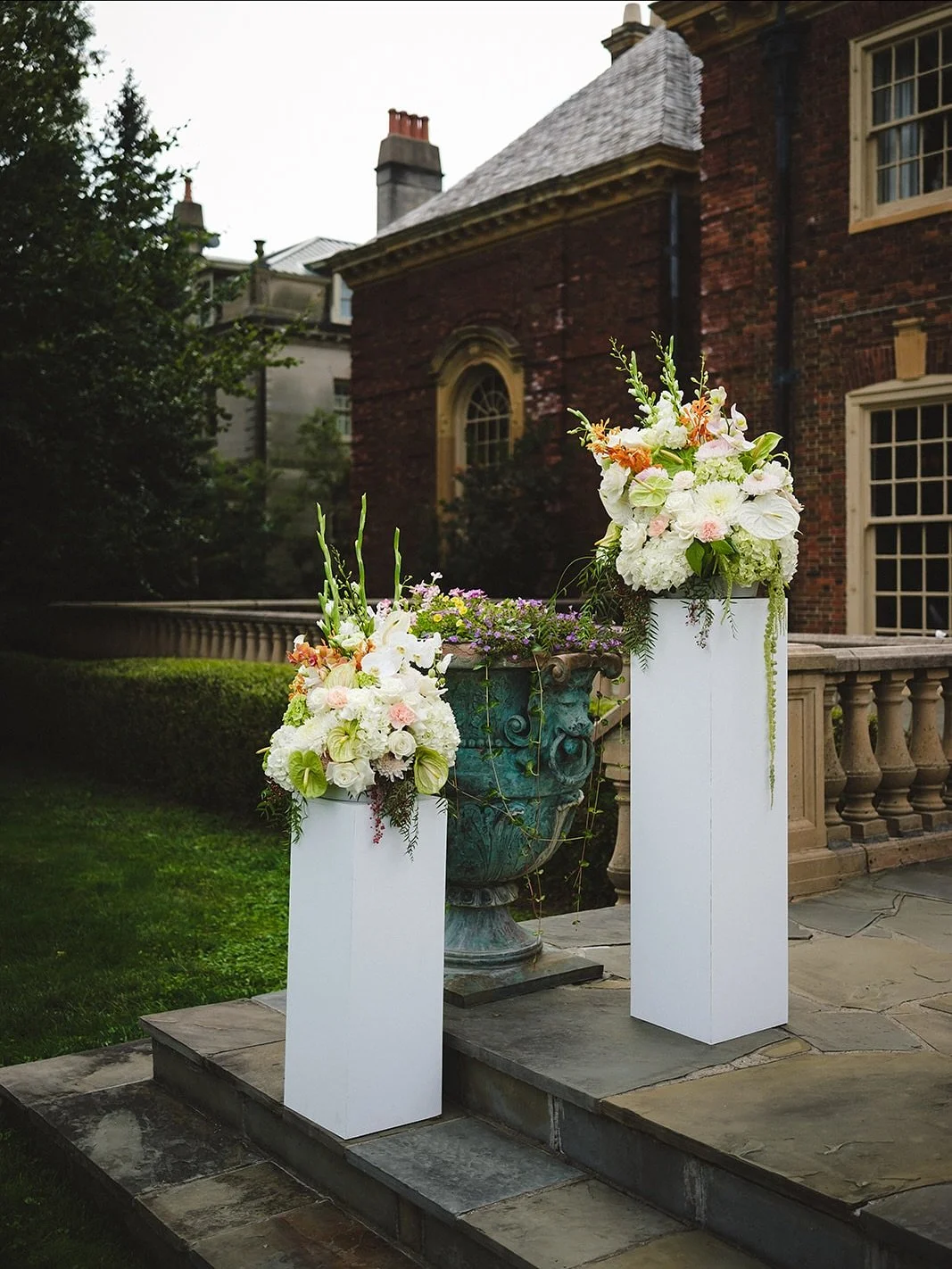 Ceremony &amp; Reception decor for Chent &amp; Princess 💍

Four large pillar arrangements making a huge impact with three varieties of orchids, three colors of anthuriums, hydrangeas that thrived all day, and the coolest hanging elements of amaranth