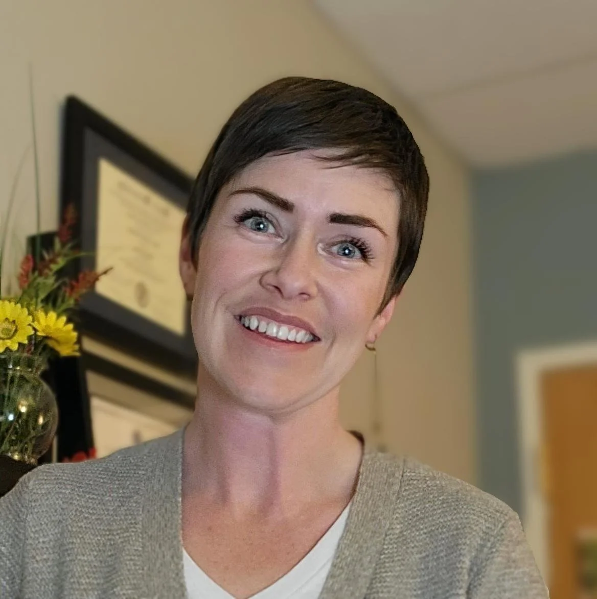 Val Bruno, a white woman with cropped dark brown hair smiling and looking at the camera. 