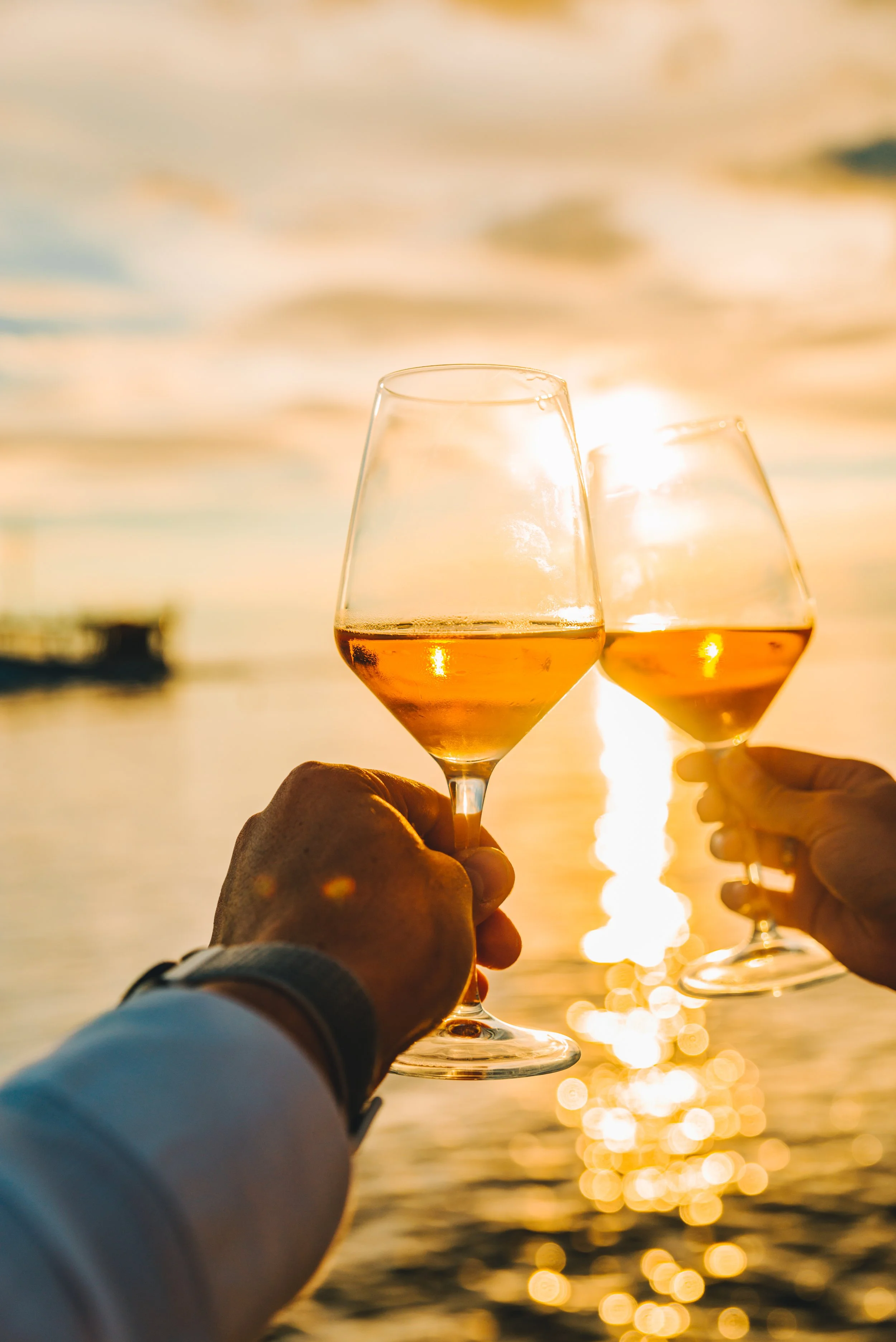 couple-resting-sunset-sea-beach-drinking-wine.jpg