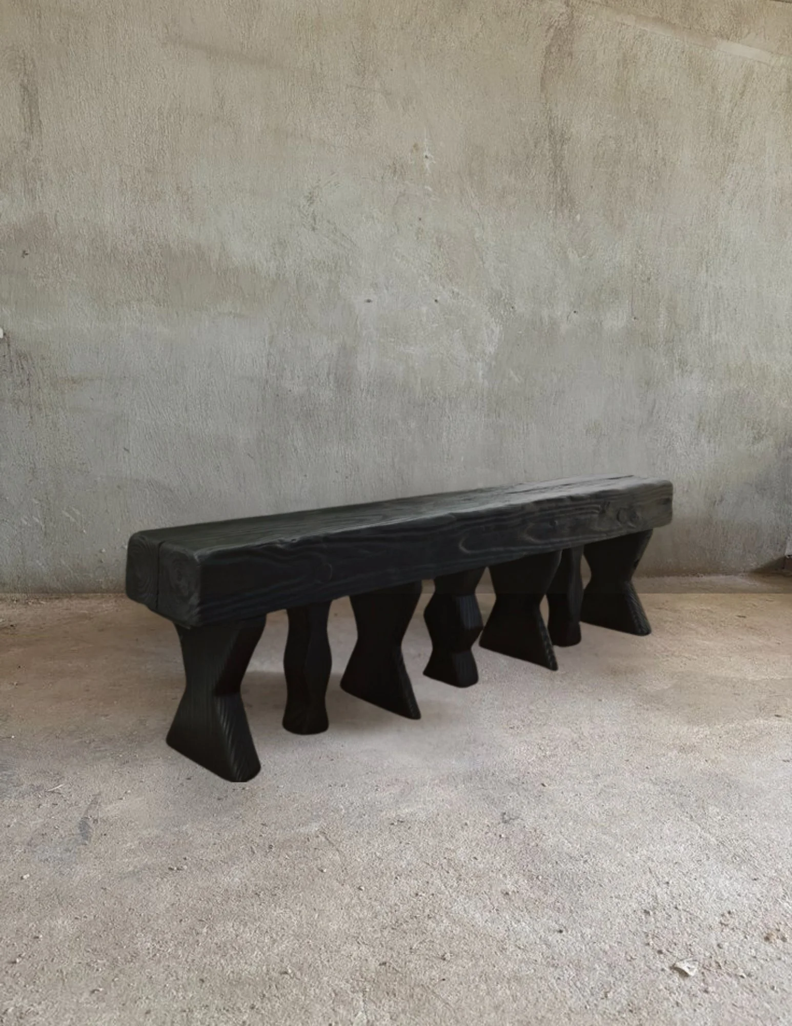 shou sugi ban wide seat bench with sculptural asymmetrical  legs