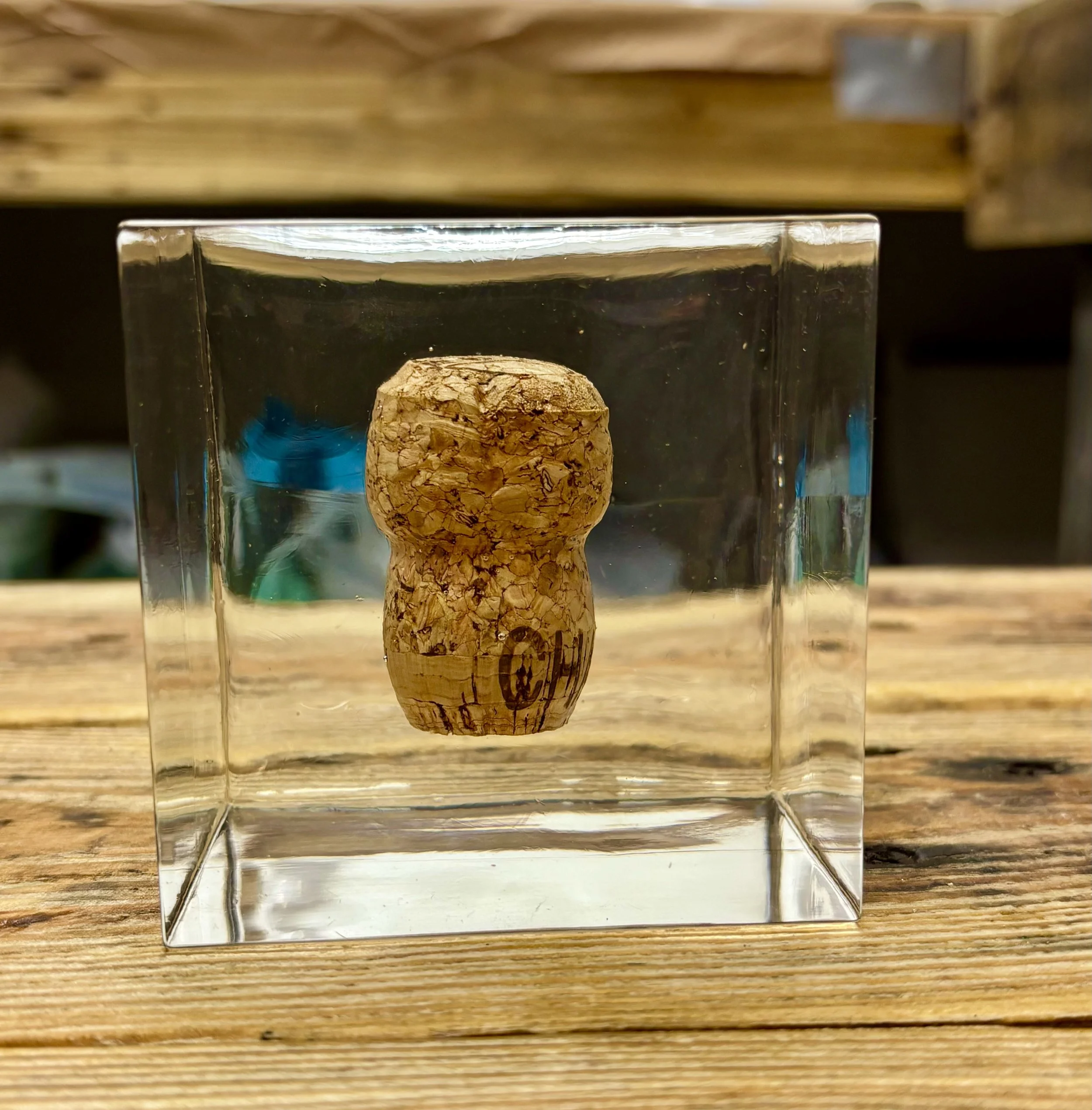 Champagne cork suspended inside a clear resin display block, handmade by Really Resin.