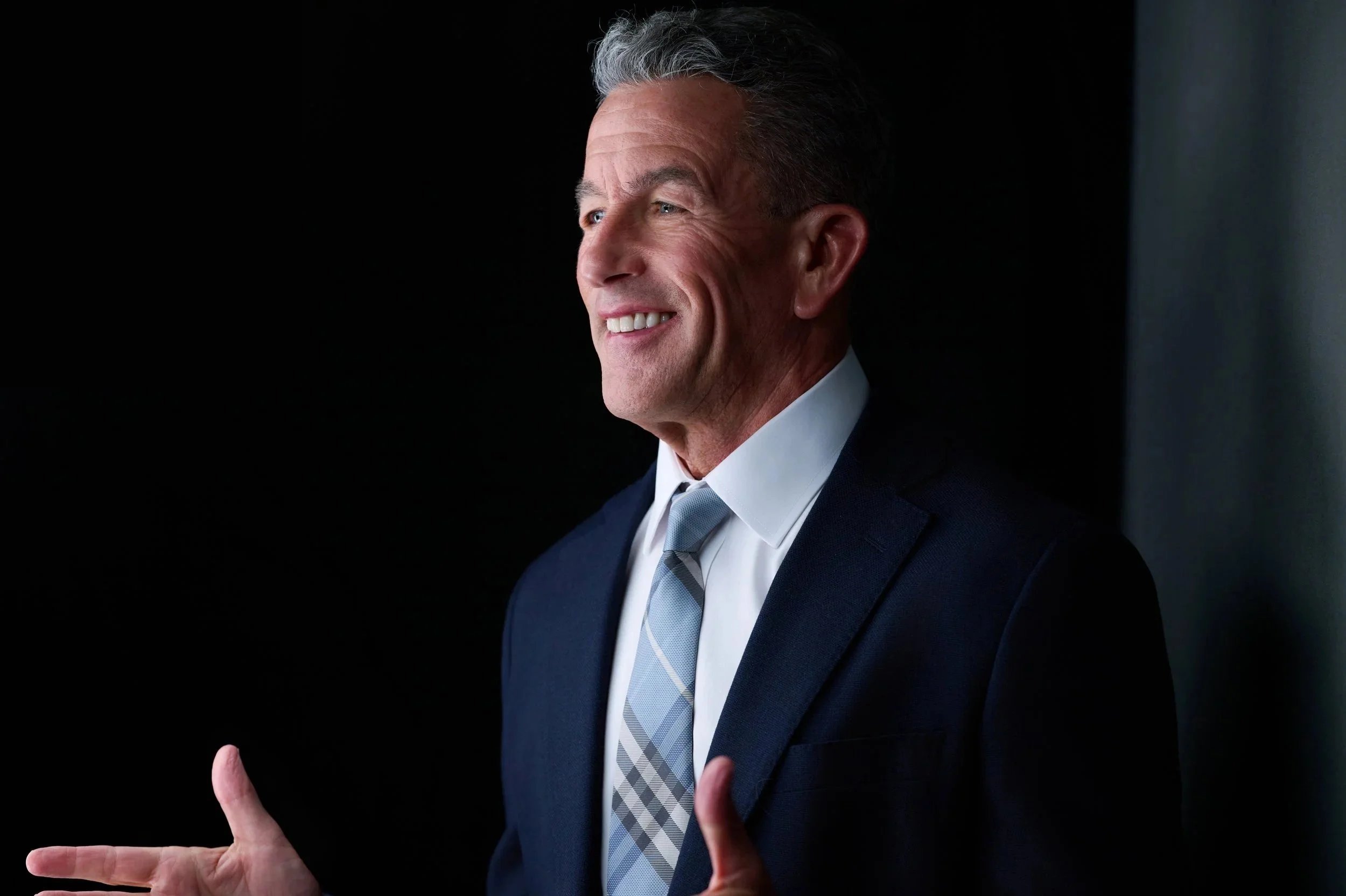 Middle aged handsome man  in blue suit speaking to a convention Fort Lauderdale