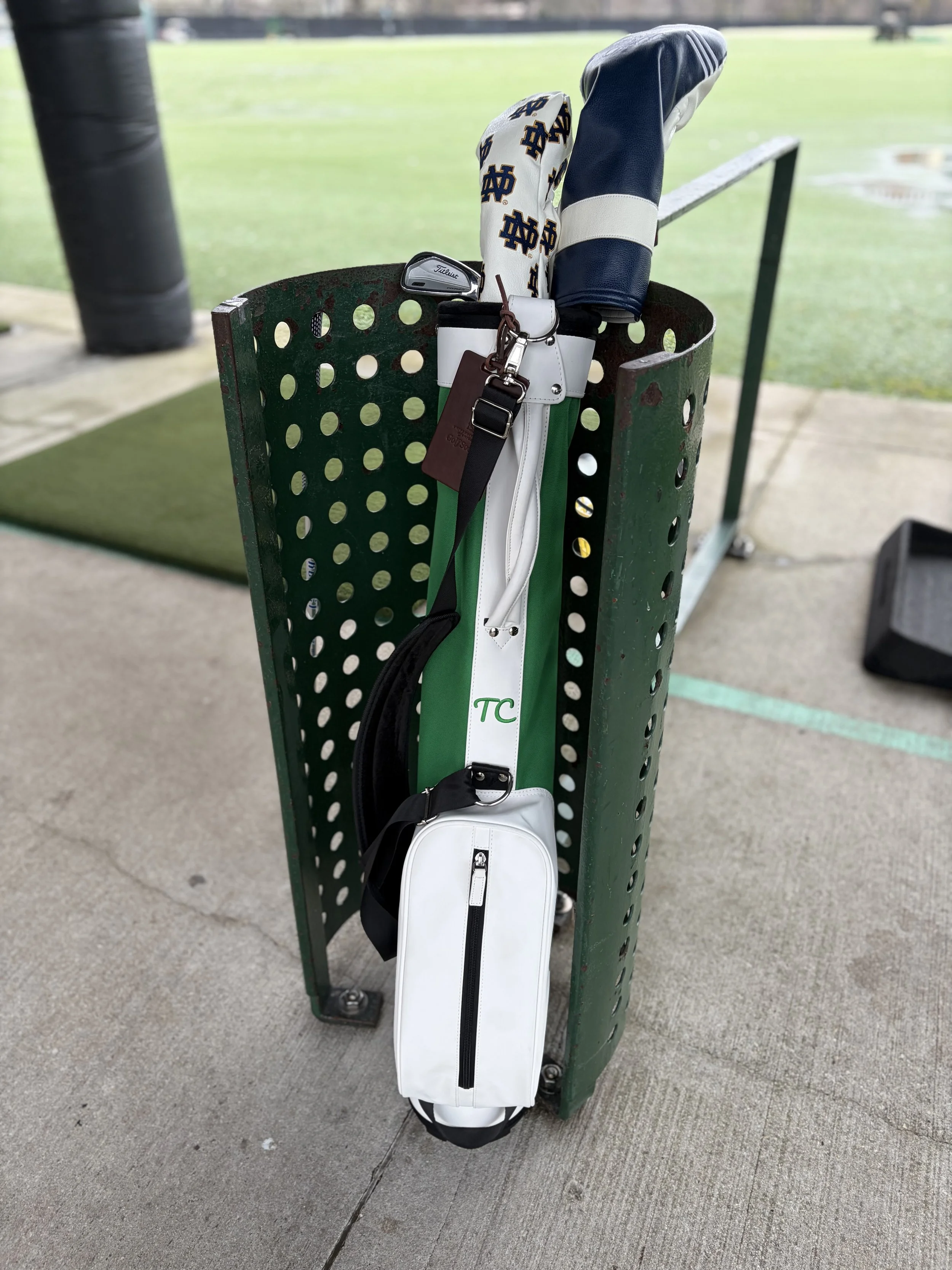 Golf clubs in a Town Caddy walking golf bag in a stall at Diversey driving range in Chicago.