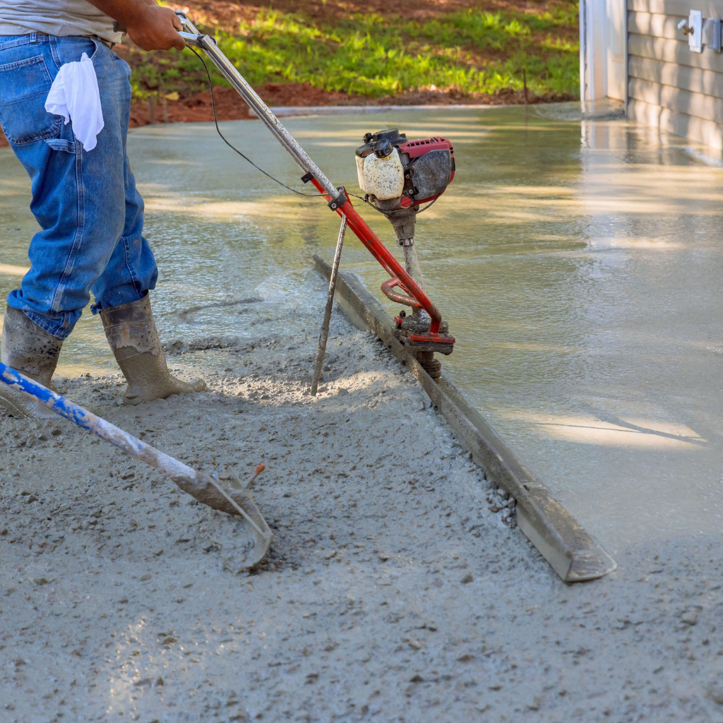 Worker resurfacing a driveway