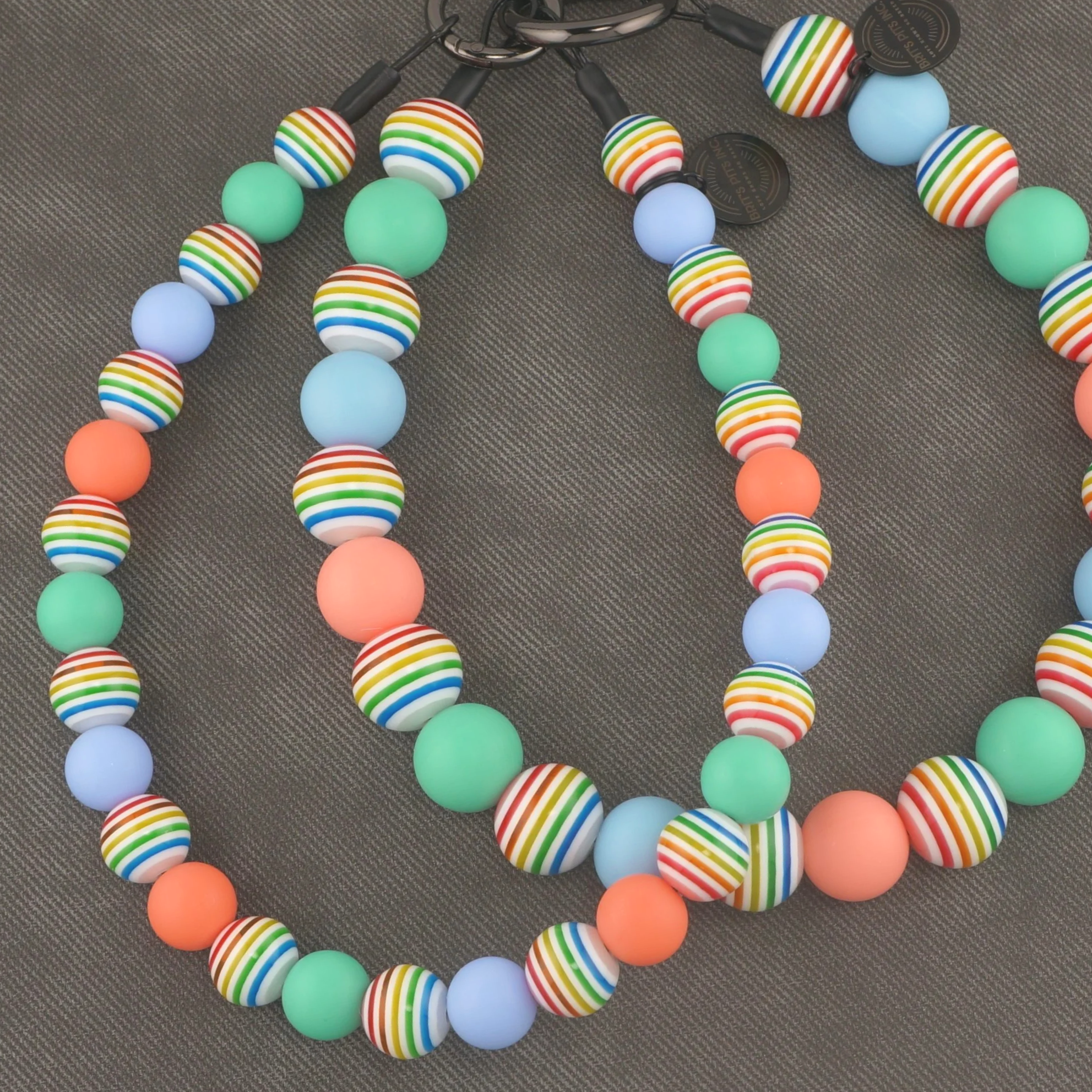Sandy Paws Social Club - Stylish beaded dog collars and necklaces with teal, light blue, pink, and rainbow stripes.