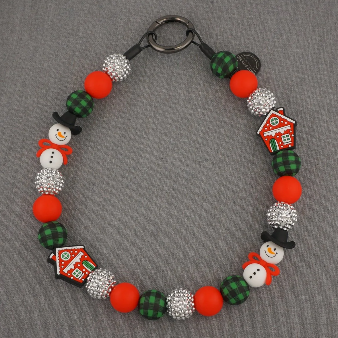 Decorative Christmas themed dog collar or necklace with snowmen and gingerbread houses.