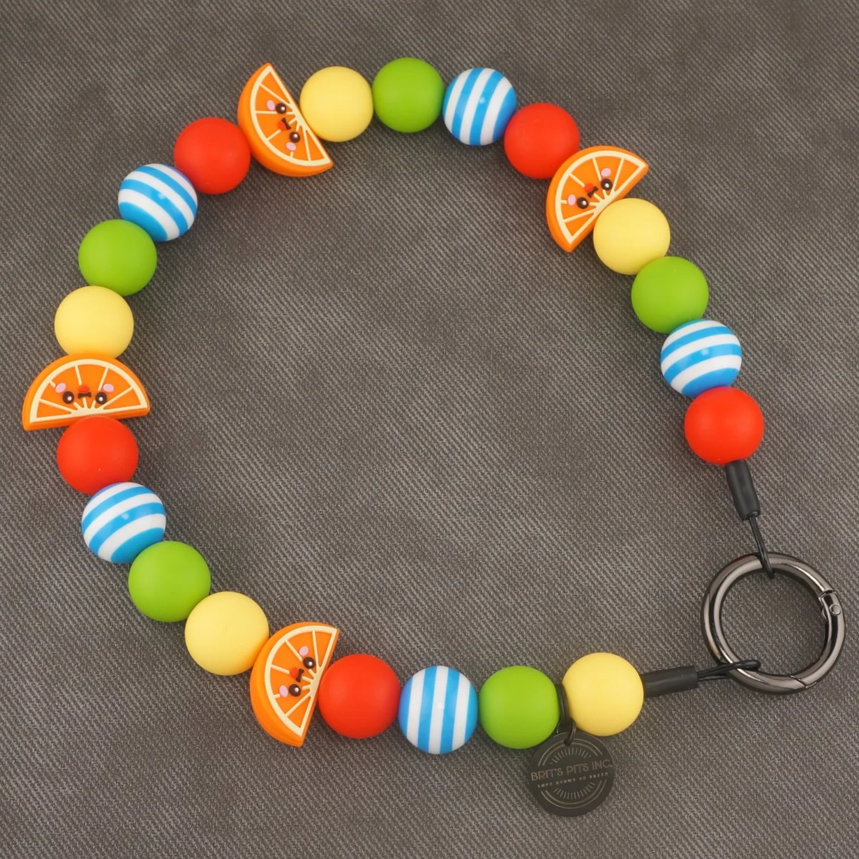 Main Squeeze - Stylish beaded dog collars and necklaces with orange slice accents, blue strips, green, yellow, and red.