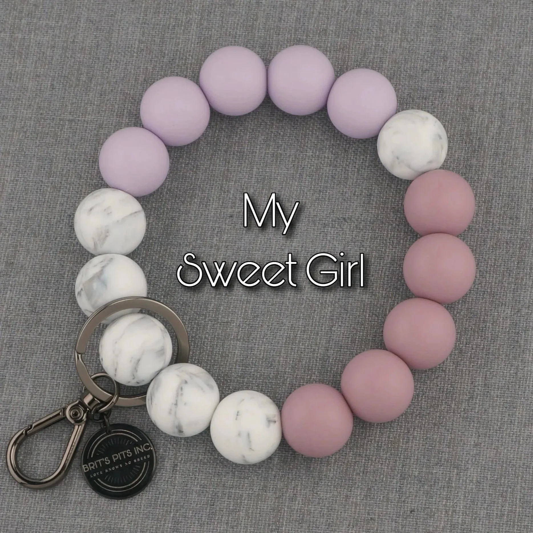 My Sweet Girl. Silicone beaded wristlet keychain in soft shades of pinks and purples with marble accents.