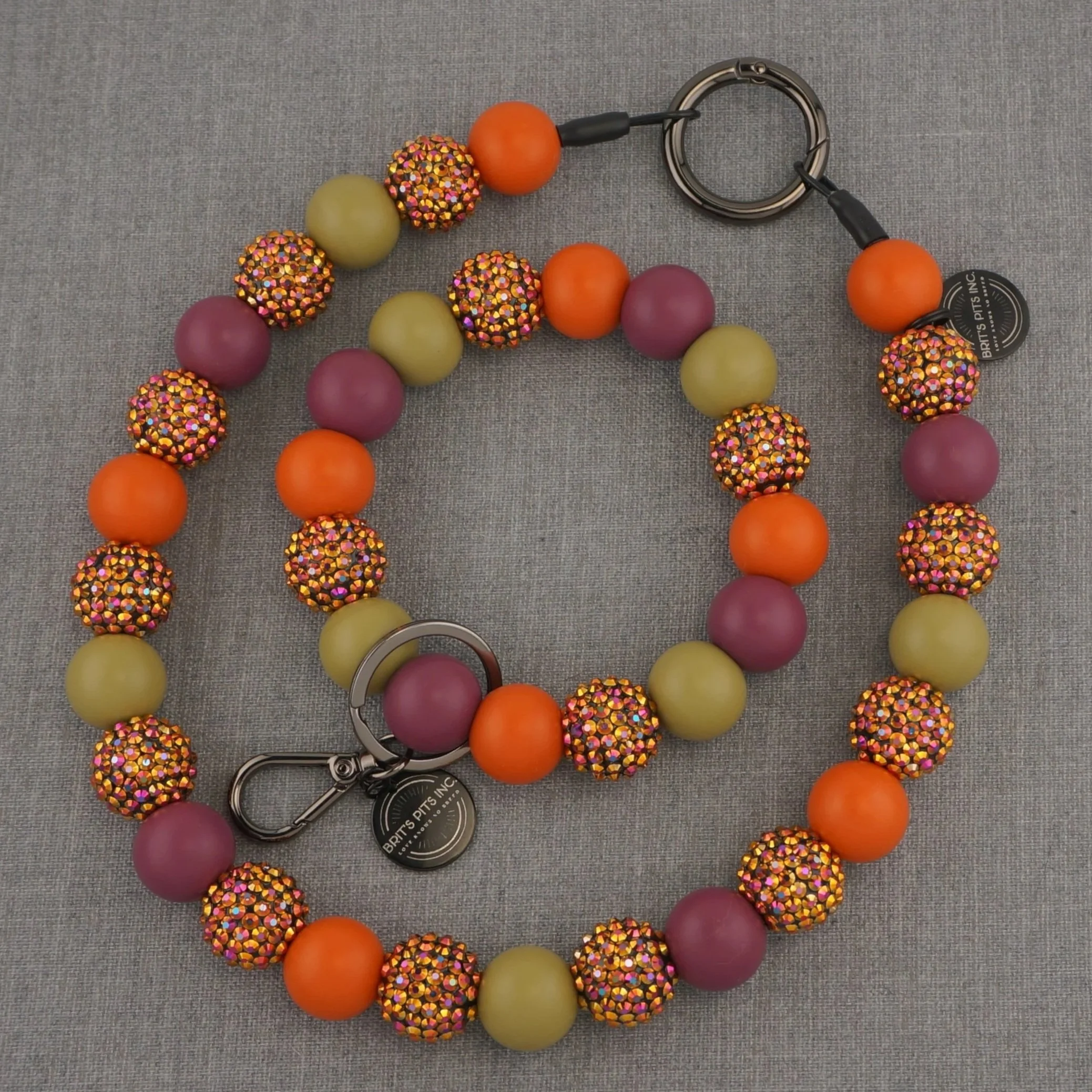 Fall inspired decorative dog collars and necklaces with orange, purple, green, and multicolored rhinestones.