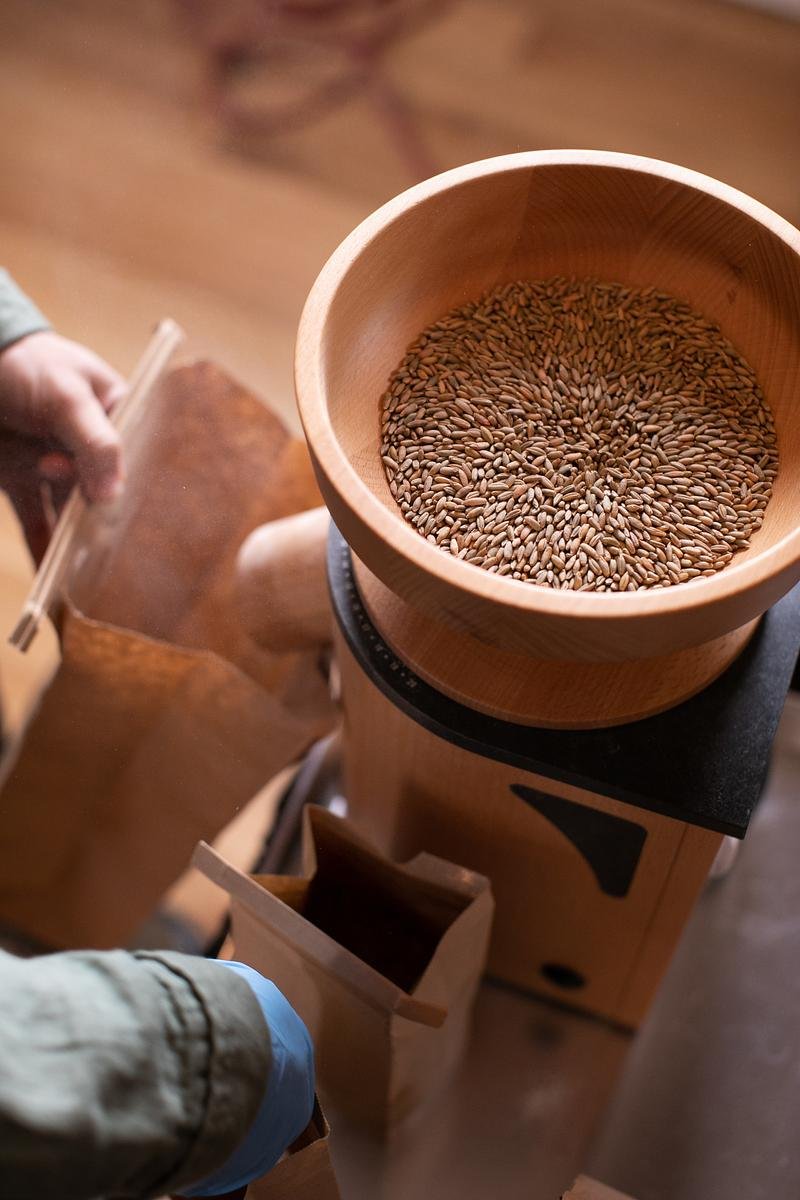 Grains are milled in a wooden table top proccessor