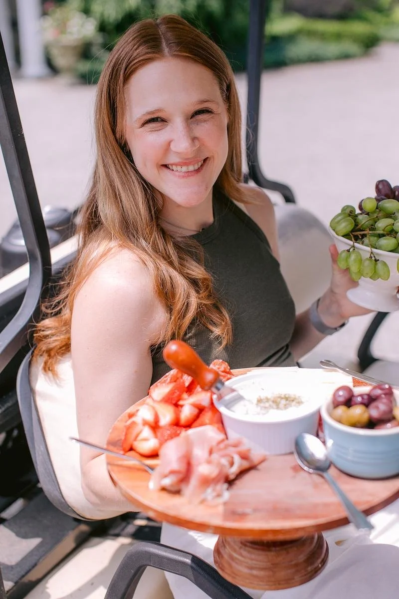 A team member holds a plate of charcuterie