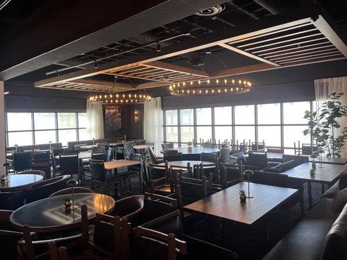 Fogo de Chão dining room with chandeliers and window wall in Phoenix, Arizona