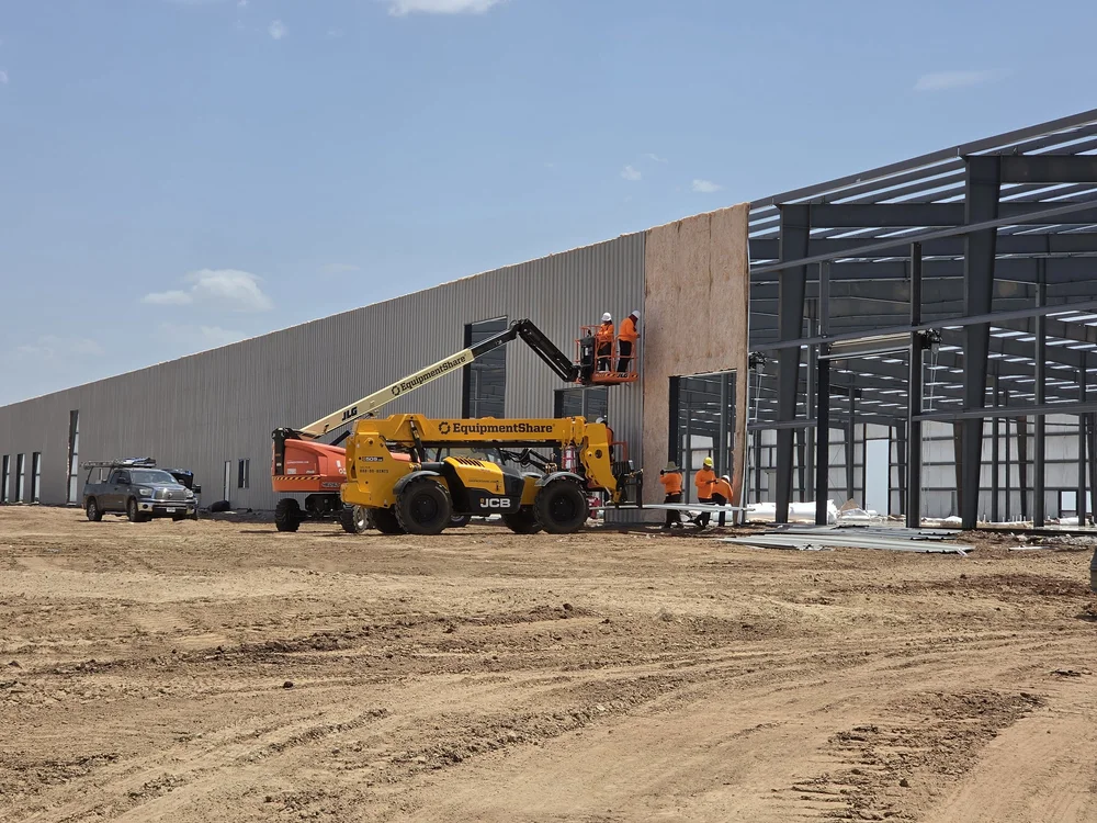 Wall panel installation from a boom lift on a data center support building