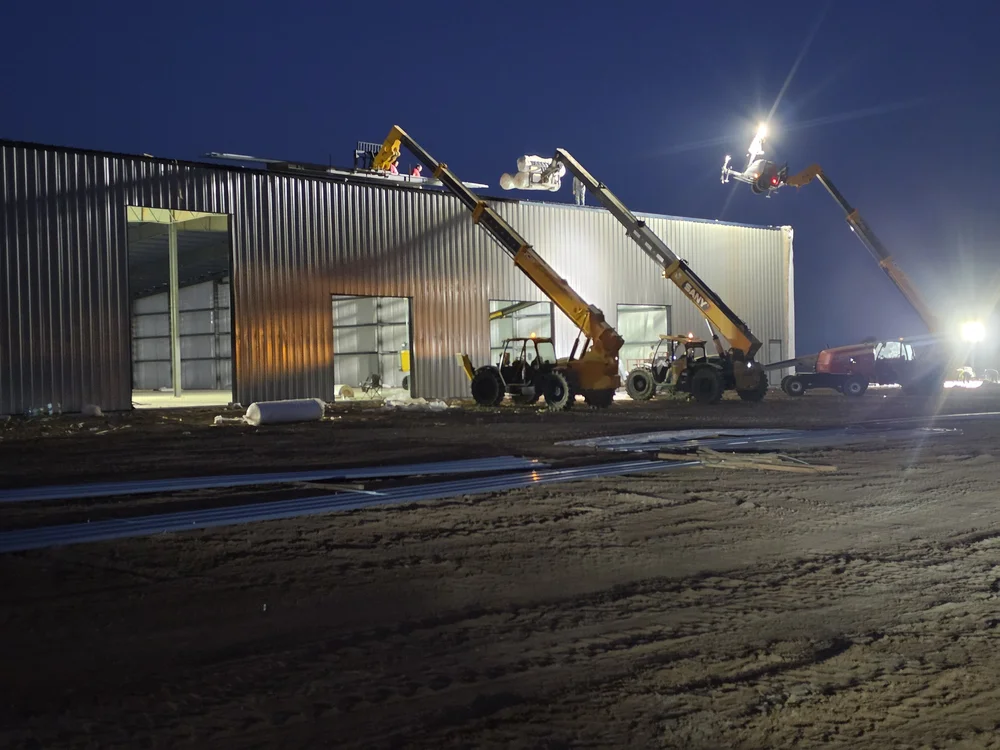 Wall cladding and overhead door openings on a data center equipment storage building
