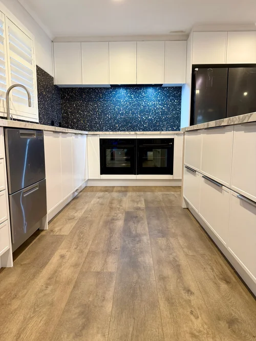 Completed contemporary kitchen renovation with warm timber cabinetry