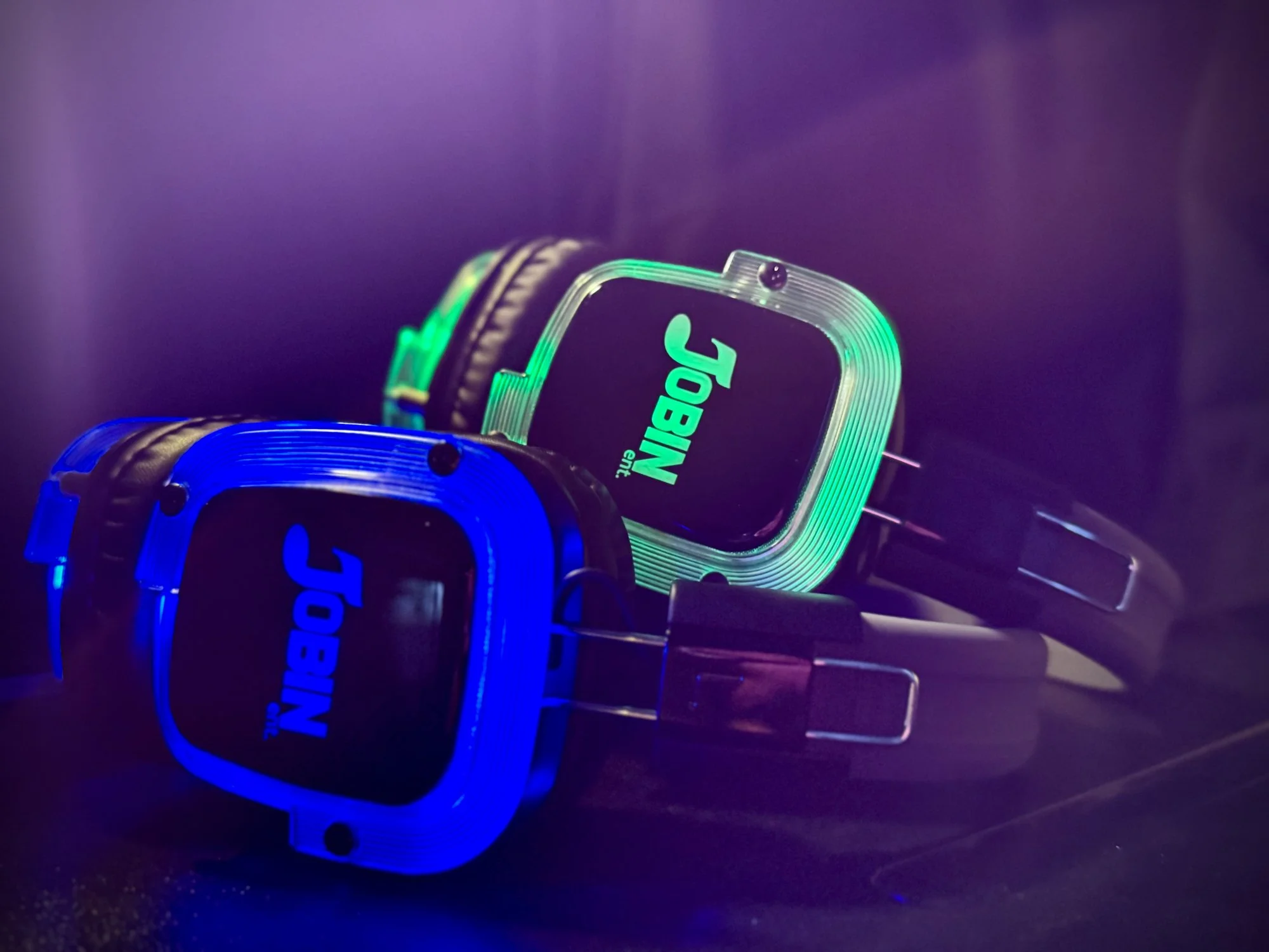 Jobin Ent. branded wireless silent disco headphones glowing blue and green