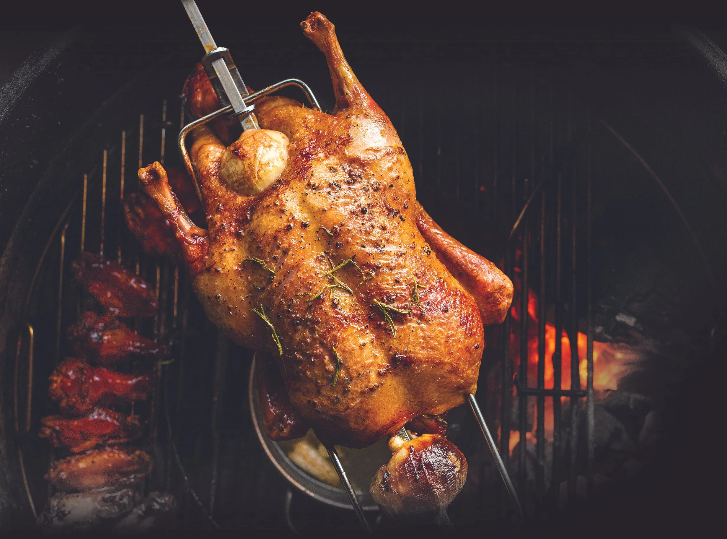 Close up of a chicken, slow cooked on a barbecue grill