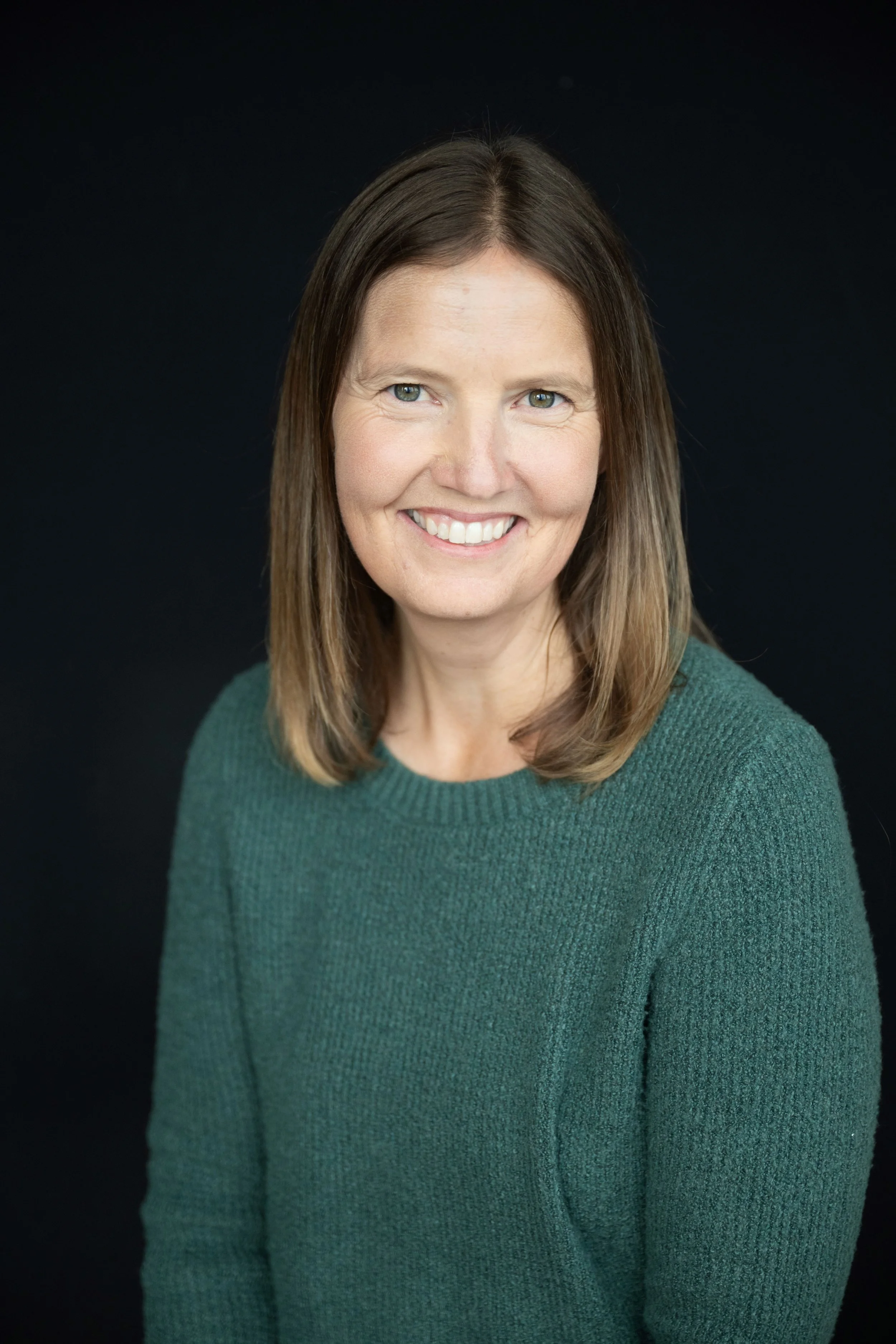 Smiling woman with brown hair in outdoor setting