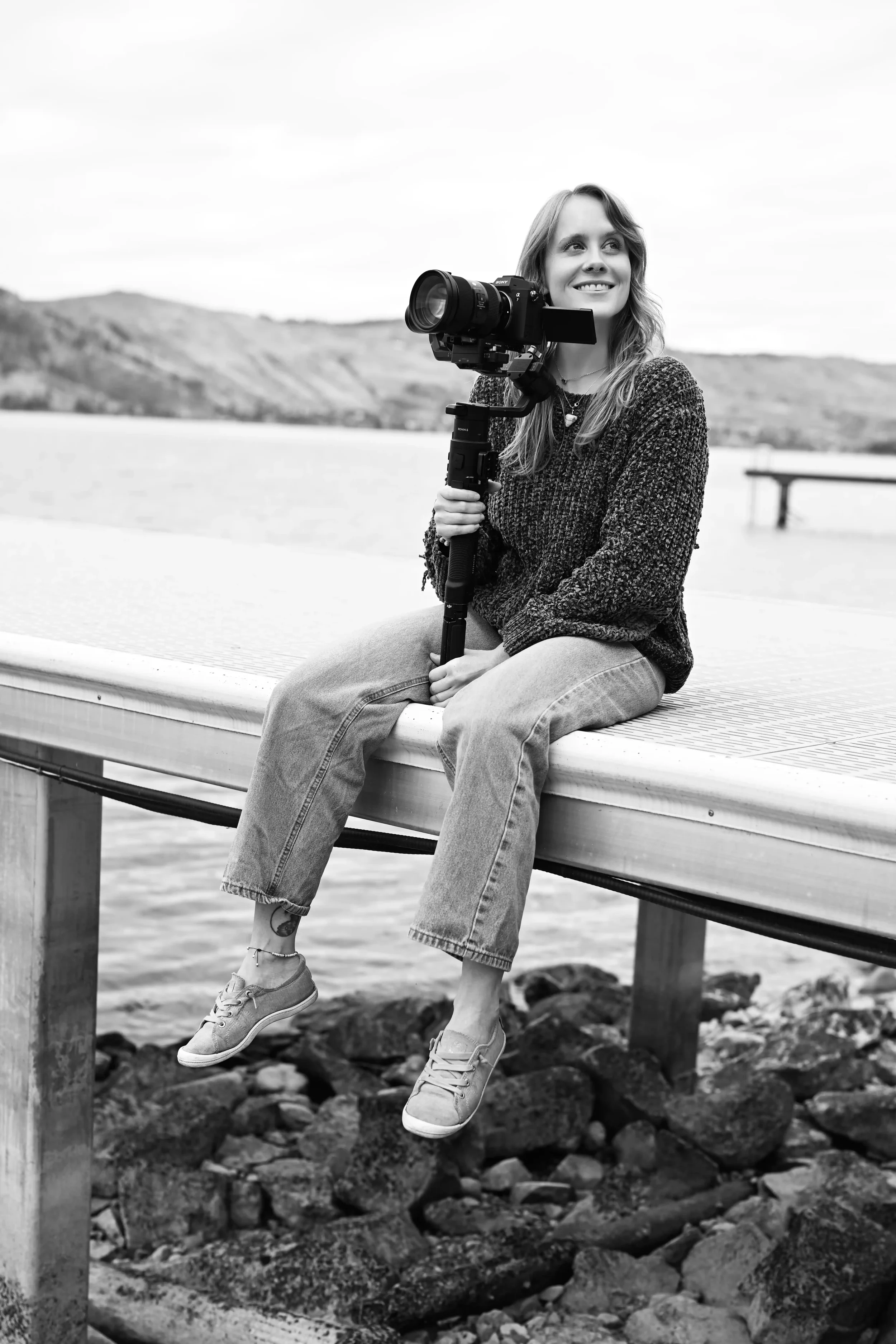 Videographer holding a camera outdoors in Vernon, BC