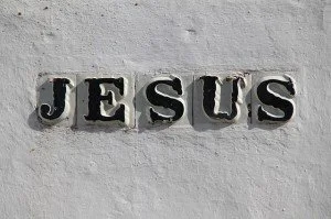 Metal letters spelling 'JESUS' mounted on a white wall.