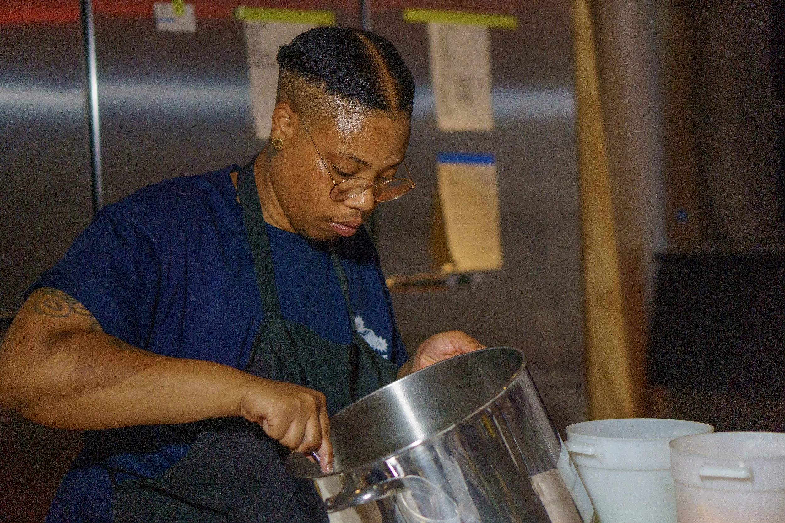Chef is holding a pot as they prepare food