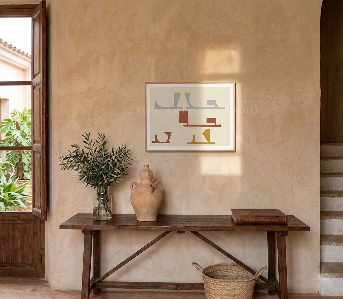 Horizontal abstract fine art print styled on a textured warm plaster wall over a rustic wooden console table with an olive branch vase and terracotta jug.