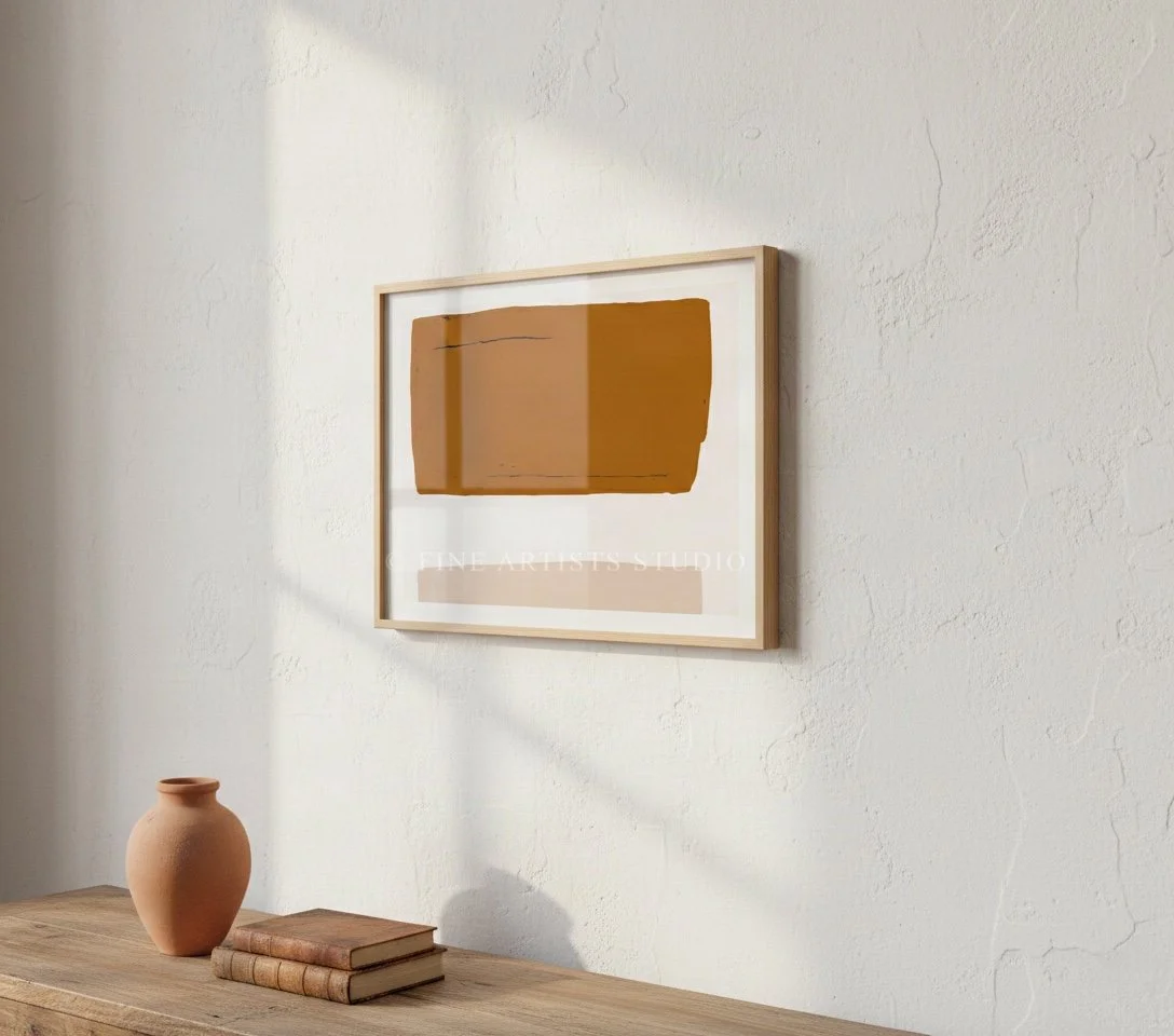 Framed modern abstract geometric print hanging on a neutral wall above a wooden table with organic ceramic stools and decorative vases.