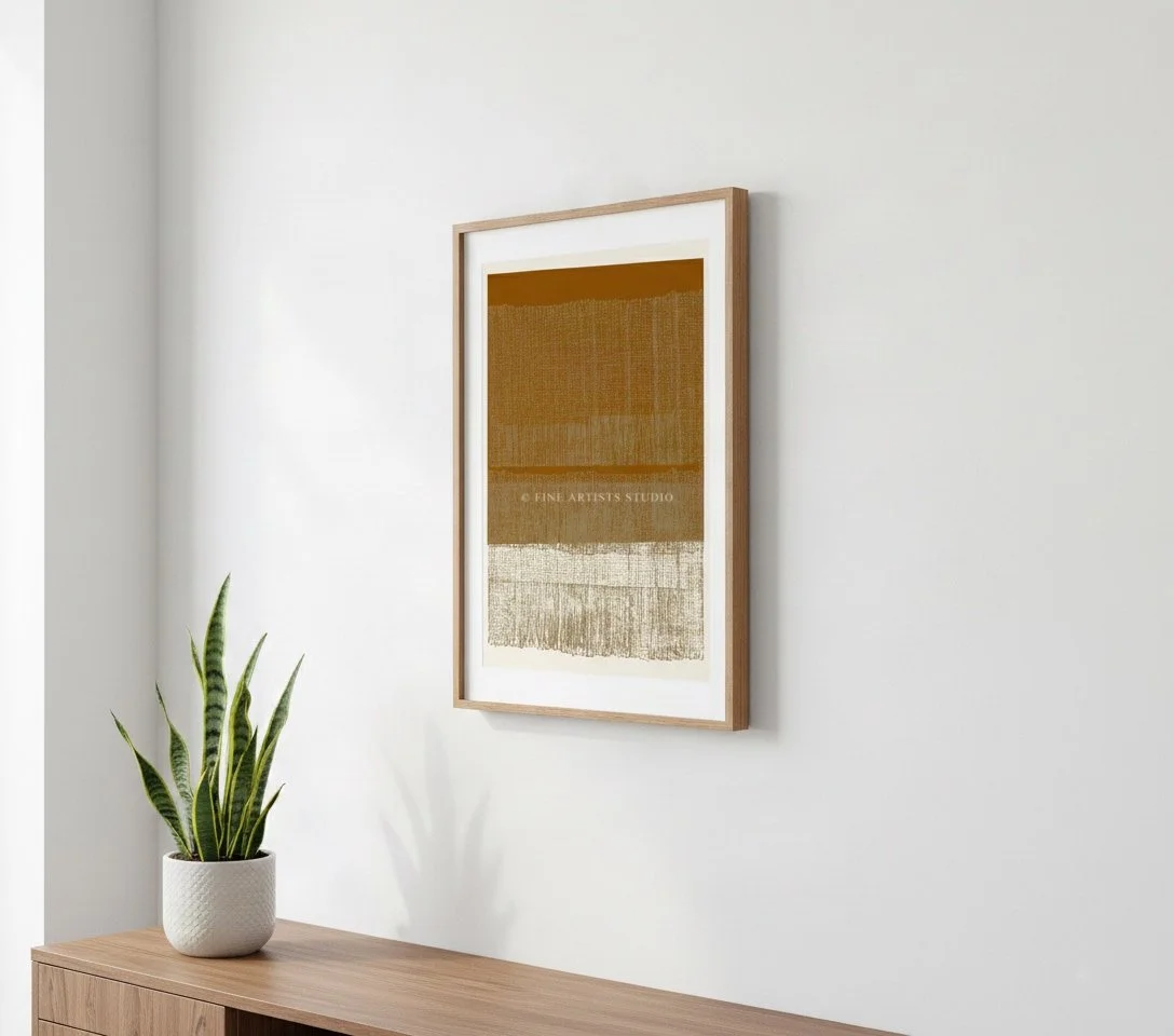 Framed abstract art print Terra d’Ombra by Aggeliki Dimitriadou on a white wall above a wooden console table with a snake plant.