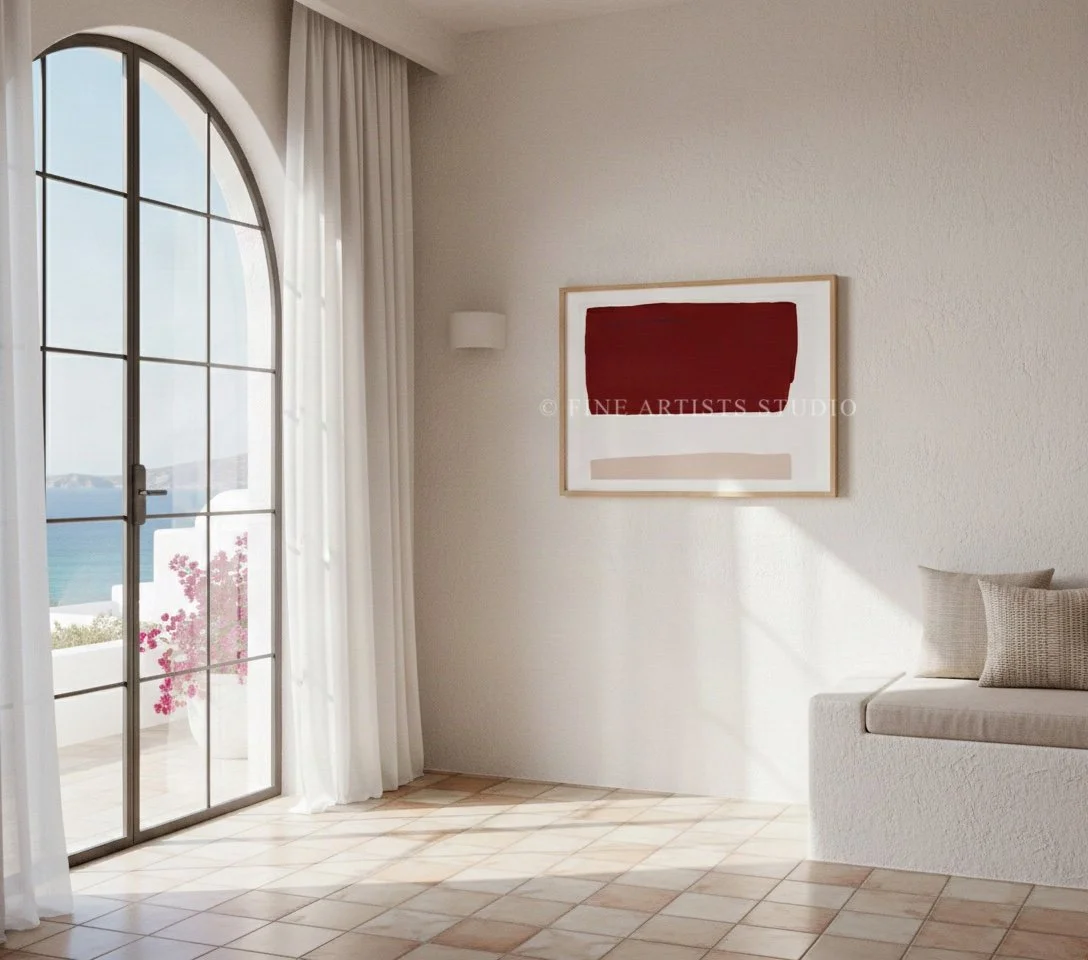 Modern abstract geometric print framed in oak, hanging on a neutral wall above a contemporary minimalist low-profile sofa.