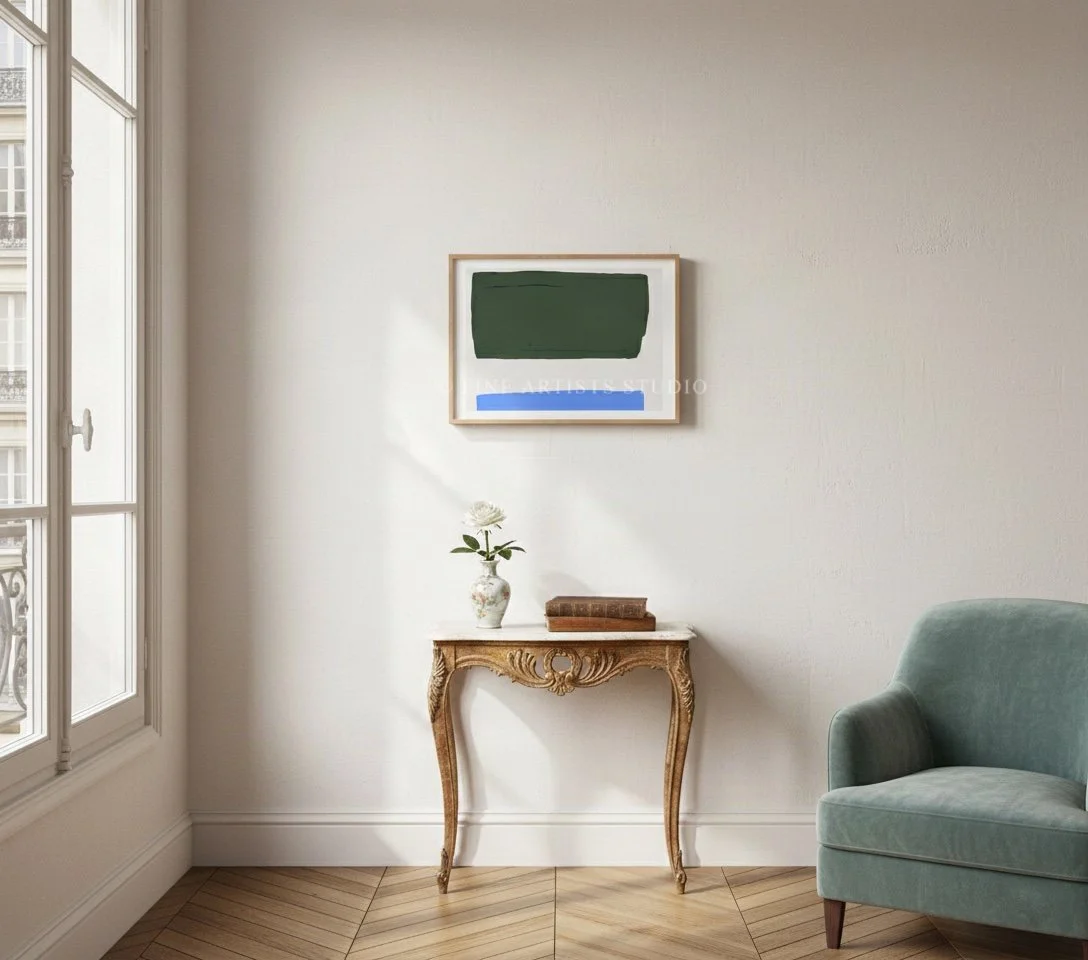 thereal green and light blue gradient artwork hanging in a peaceful, minimalist bedroom beside a green armchair.