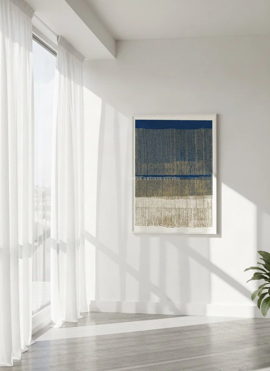 Framed blue abstract print Terra d'Oltremare from Layers series styled in a bright room with soft white curtains.