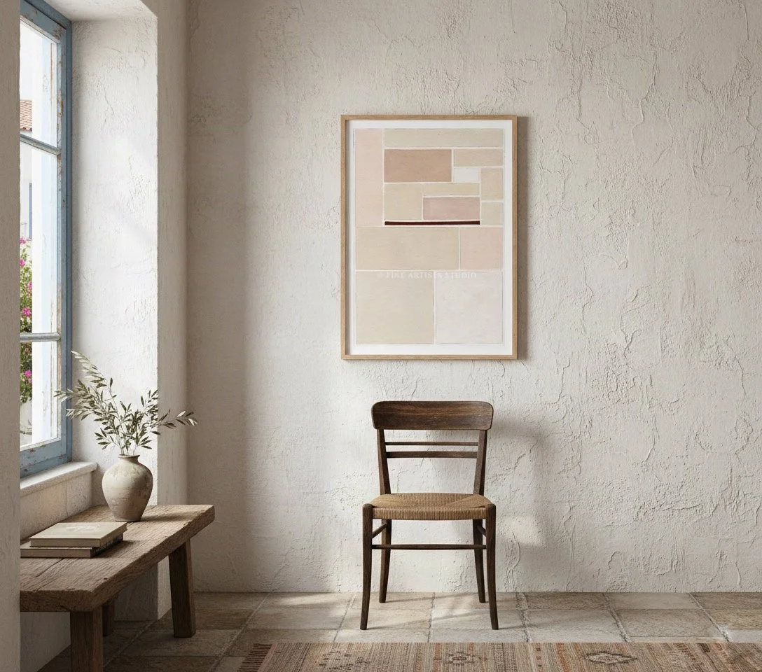 Framed abstract print SCHEMA II by Aggeliki Dimitriadou for Fine Artists studio on a white stucco wall above a dark wooden chair.