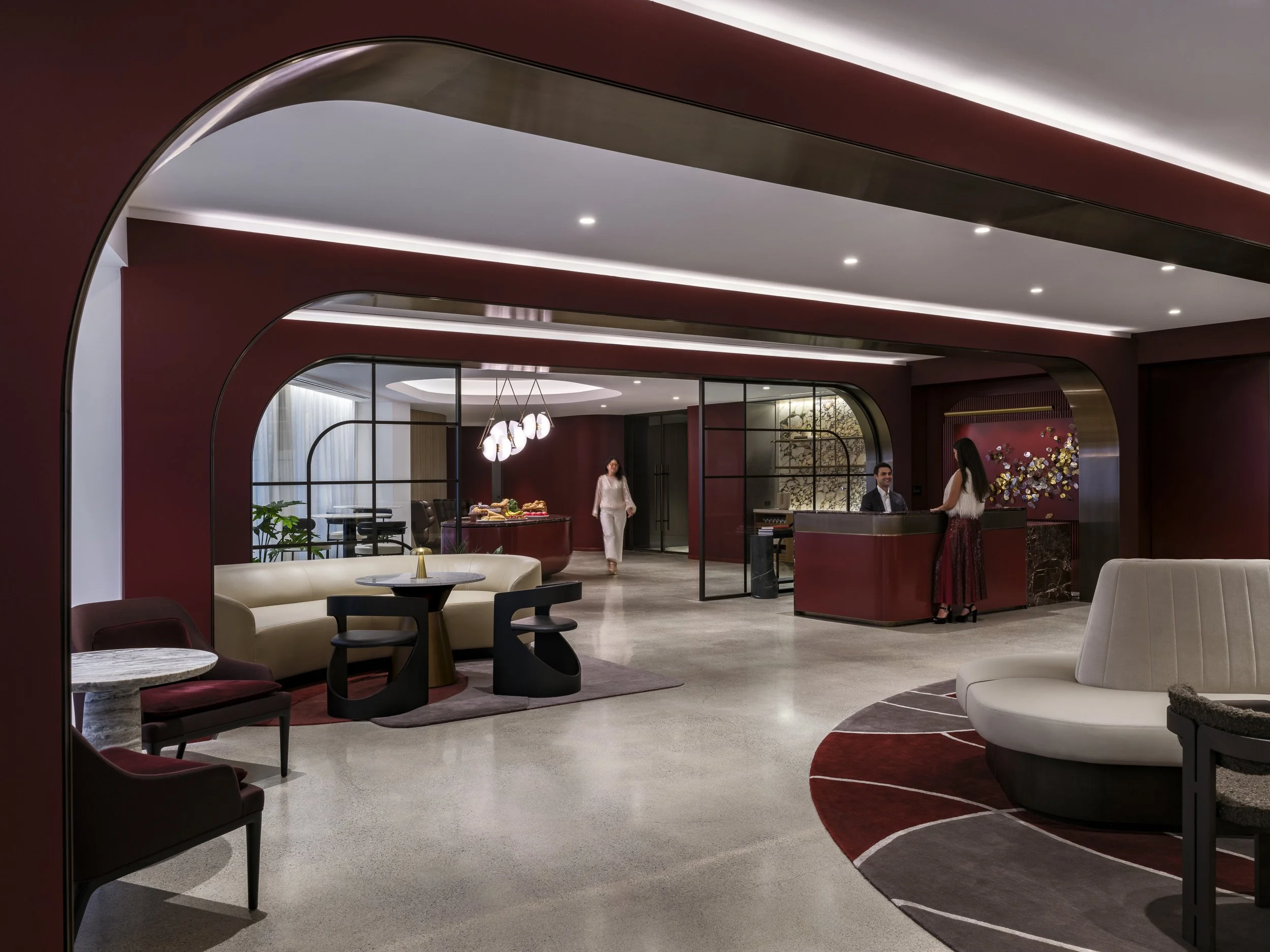Main Lobby Aries Club Designed by Gensler Boston MA modern futuristic design  three people at reception desk 