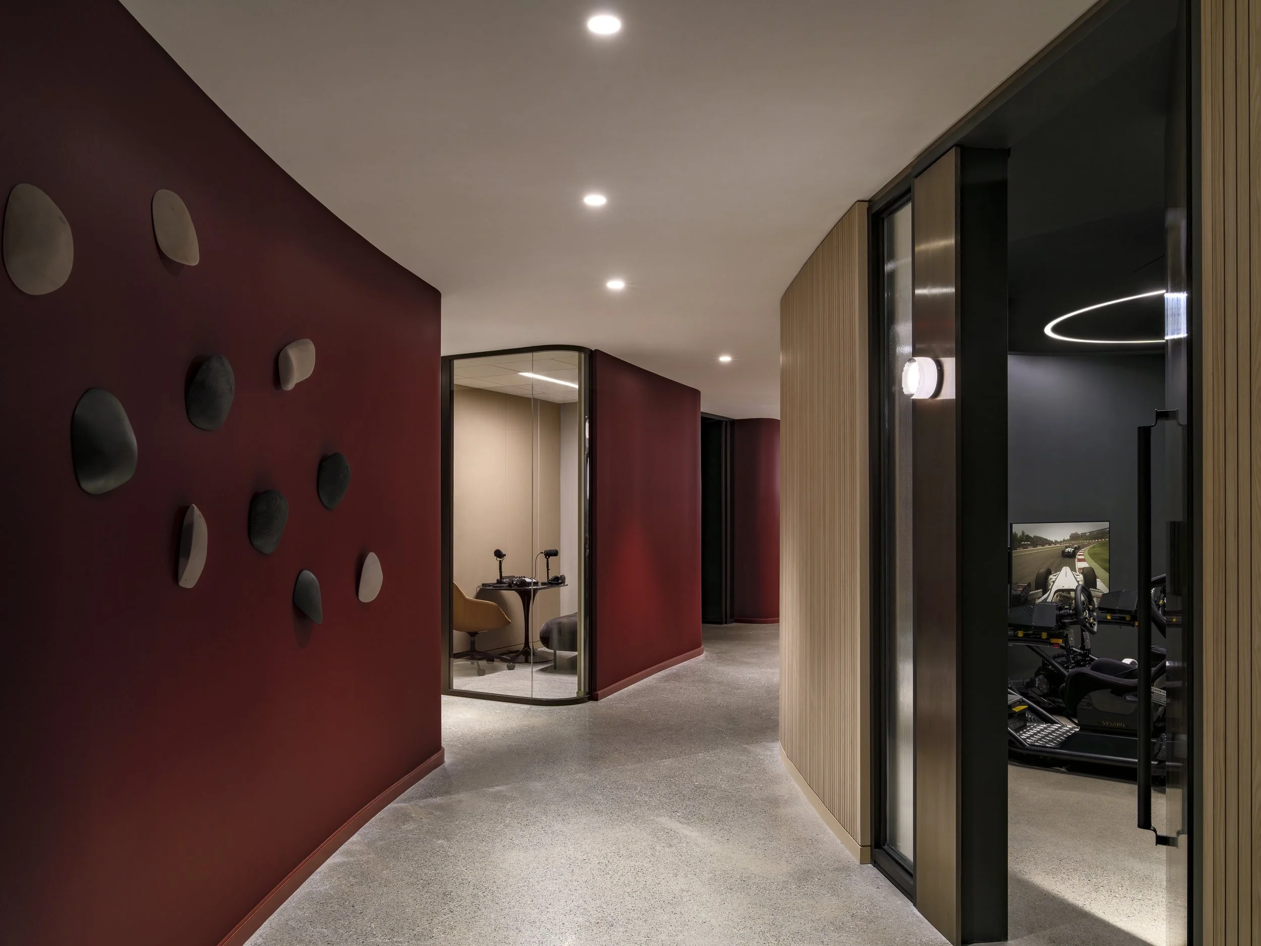 Aries Club Designed by Gensler Hallway with recording room and race sim room 