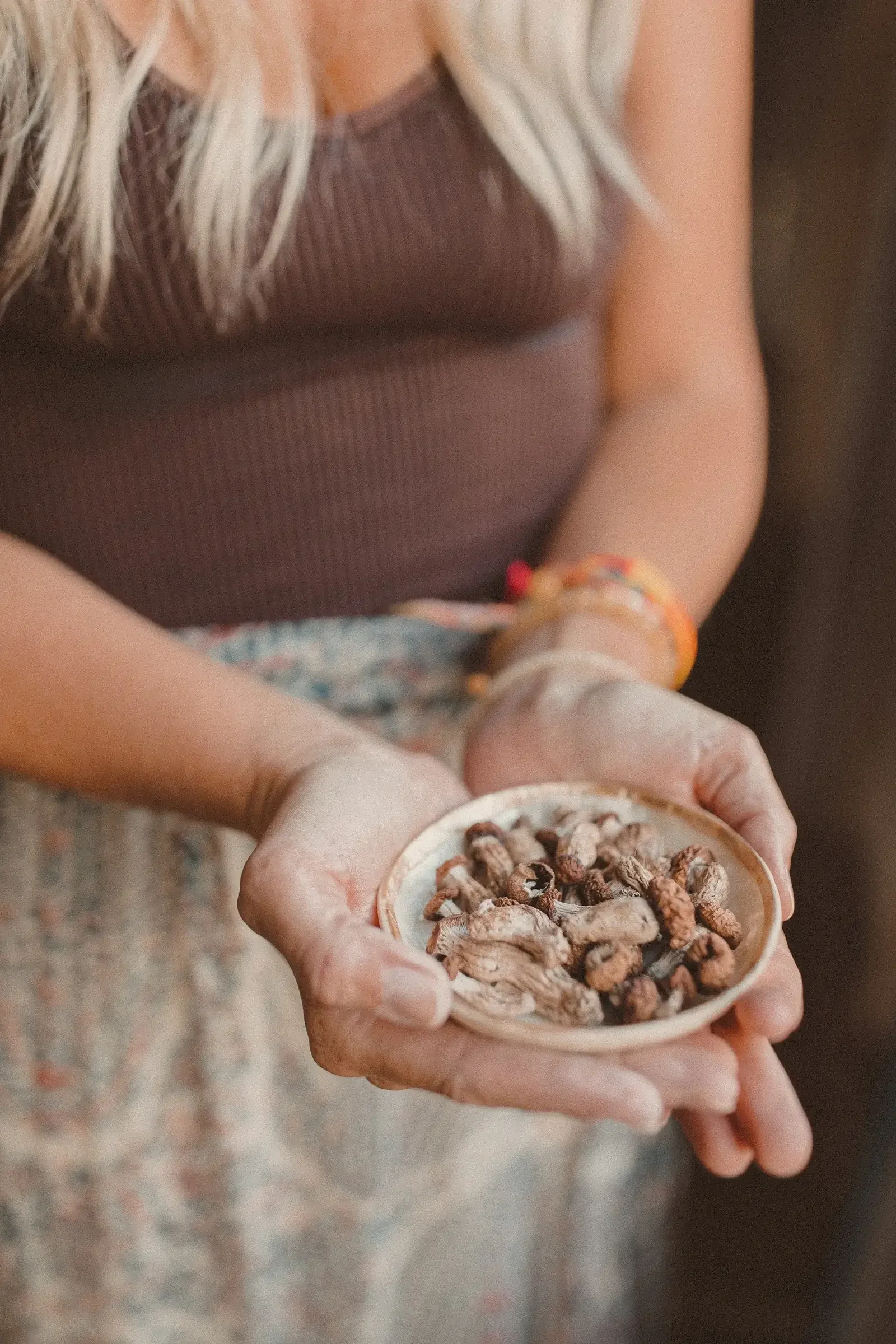 Woman holding bowl of dried fruit