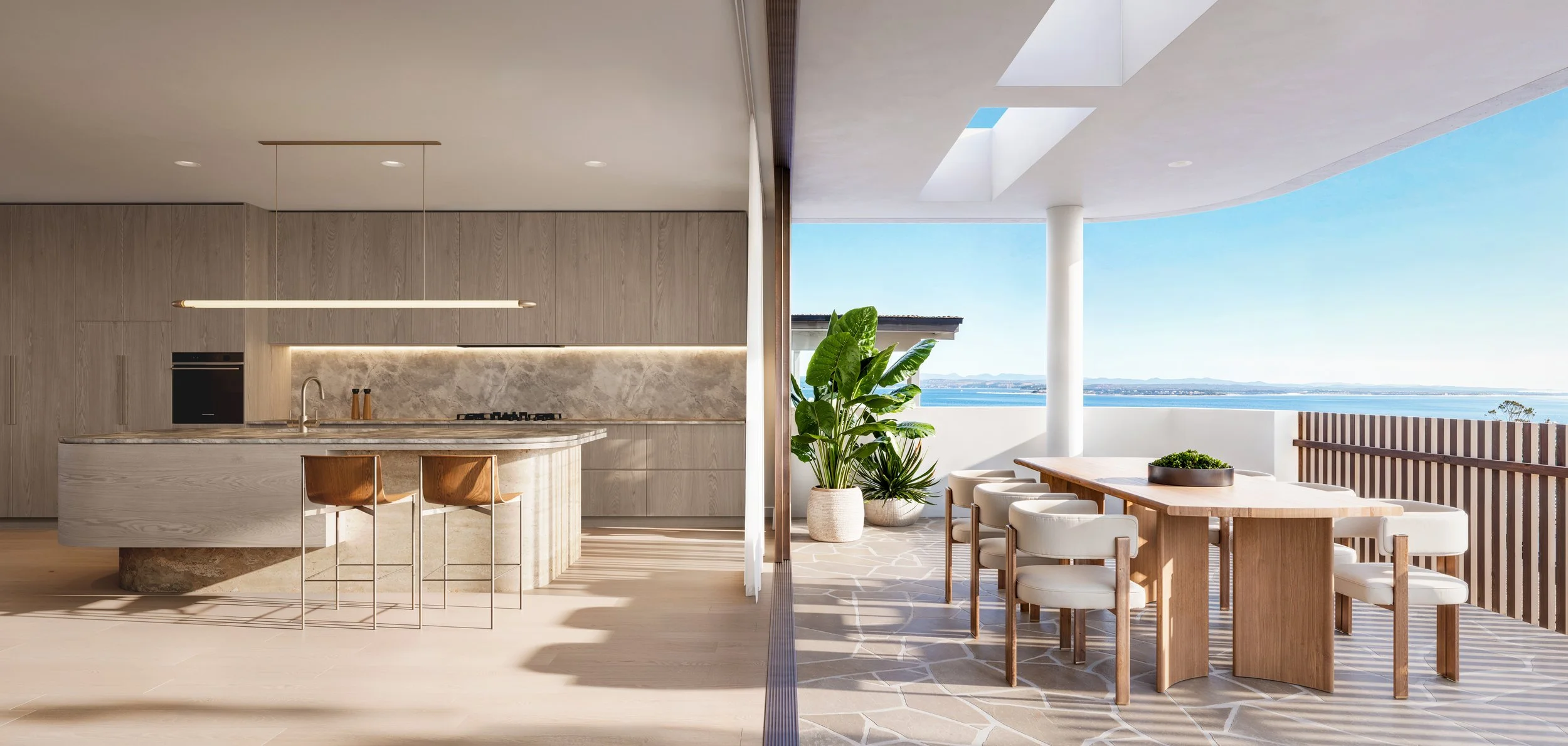 Modern outdoor balcony with beige kitchen and dining area, view of ocean and mountains, potted plants, and minimalist furniture