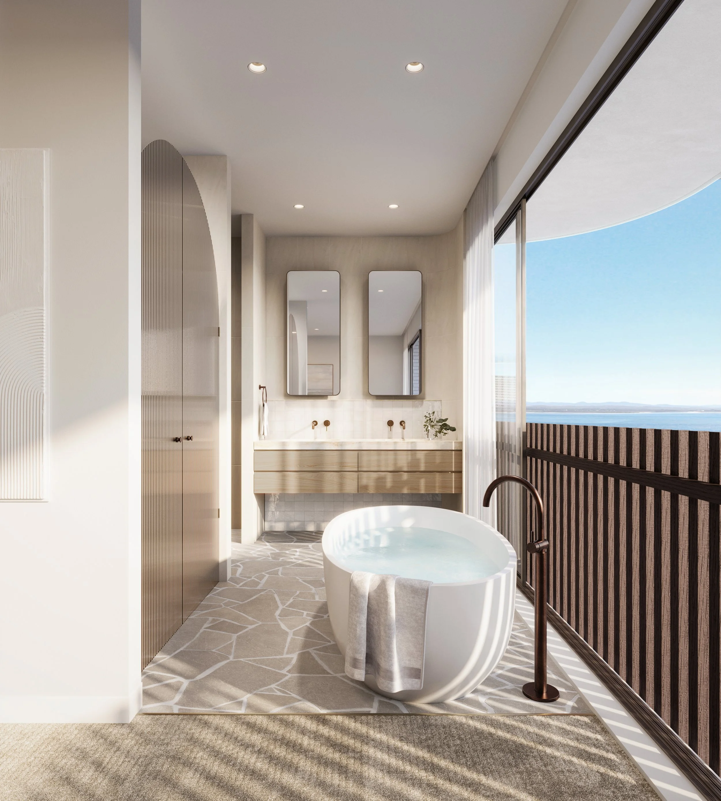 Modern bathroom with a freestanding bathtub near large glass doors showing a view of the ocean, with a tan and white patterned rug and minimal decor.
