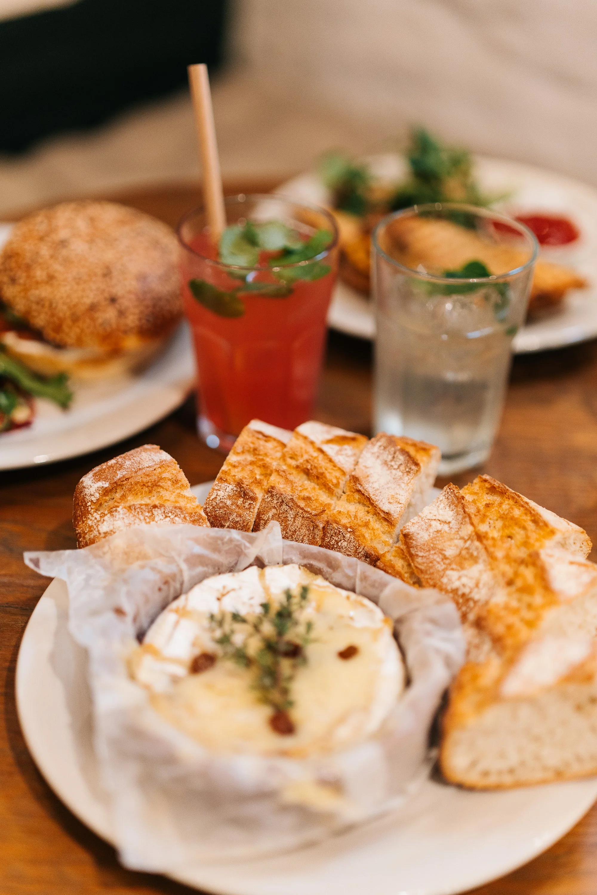 Several food options, including a baked Camembert, a croque monsieur, and a Spaans Huis signature salmon bun.